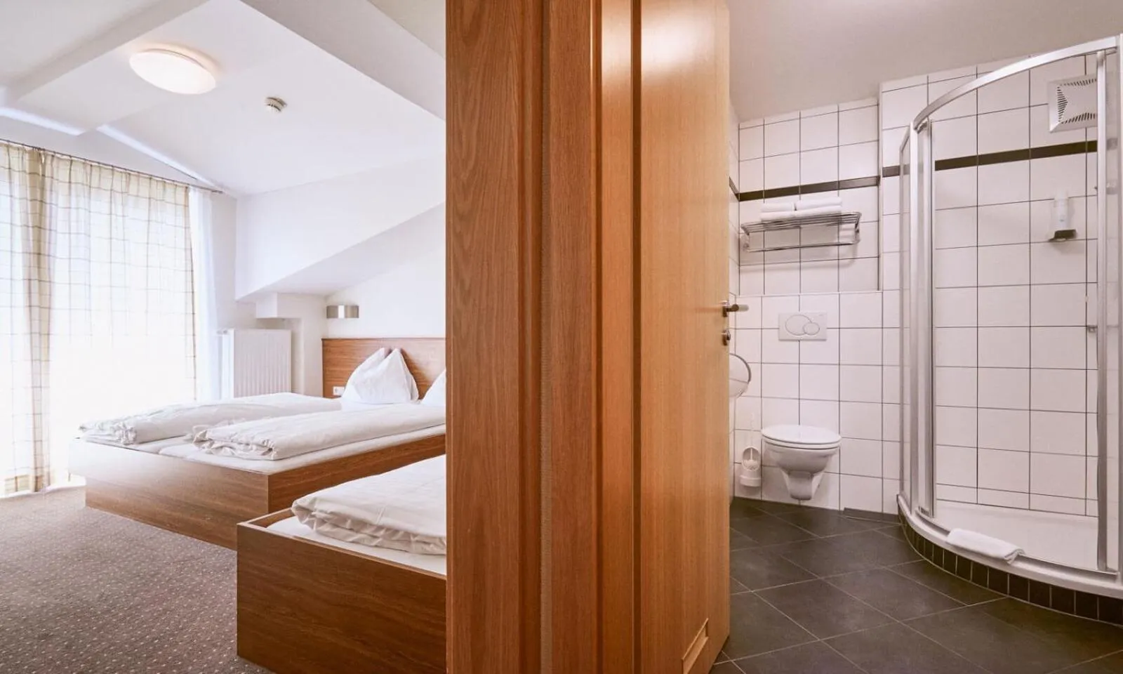 Bathroom, Bed in Hotel Pinzgauerhof by Alpeffect Hotels