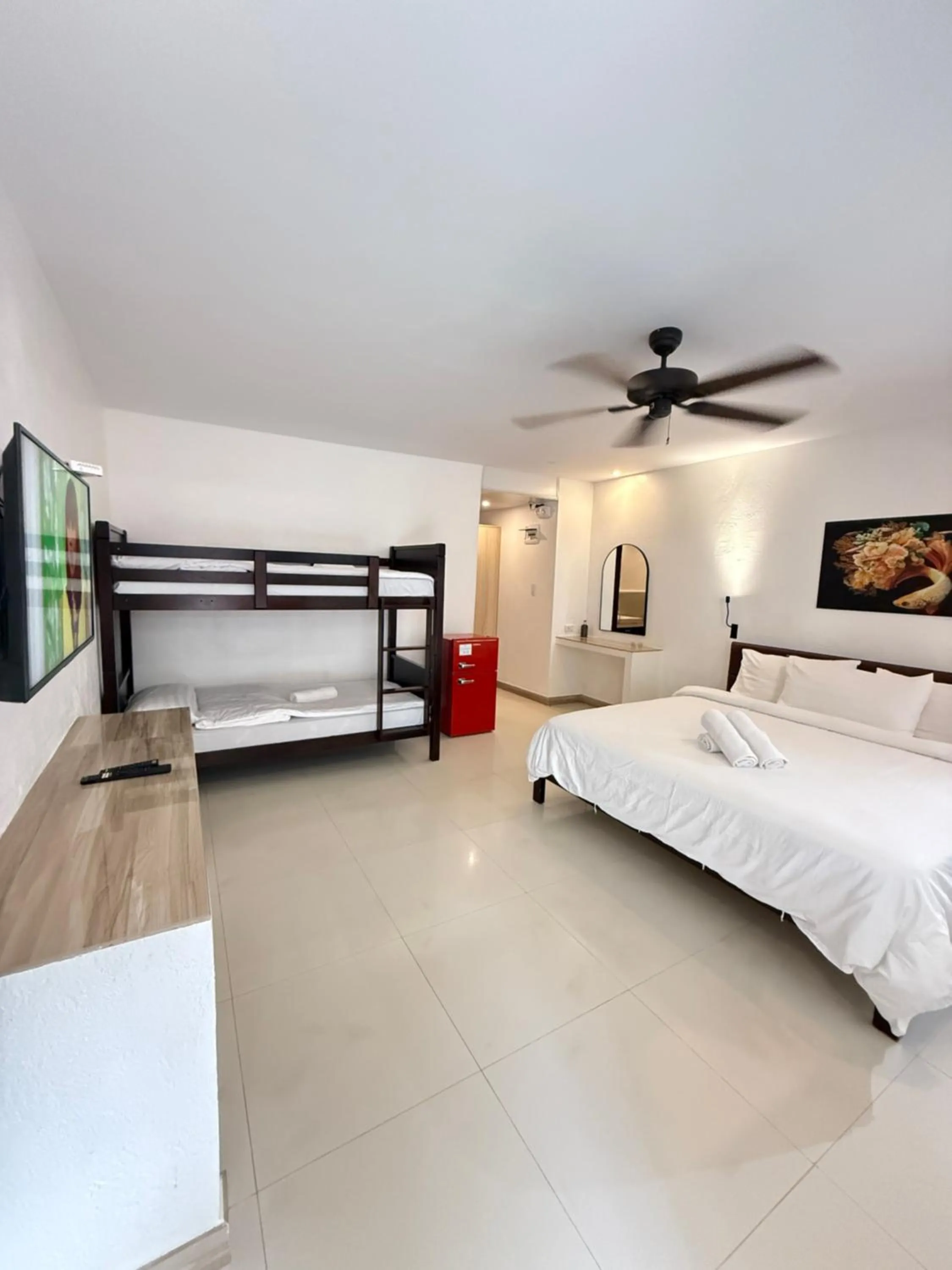 Photo of the whole room, Bed in Calypso Beach and Dive Resort