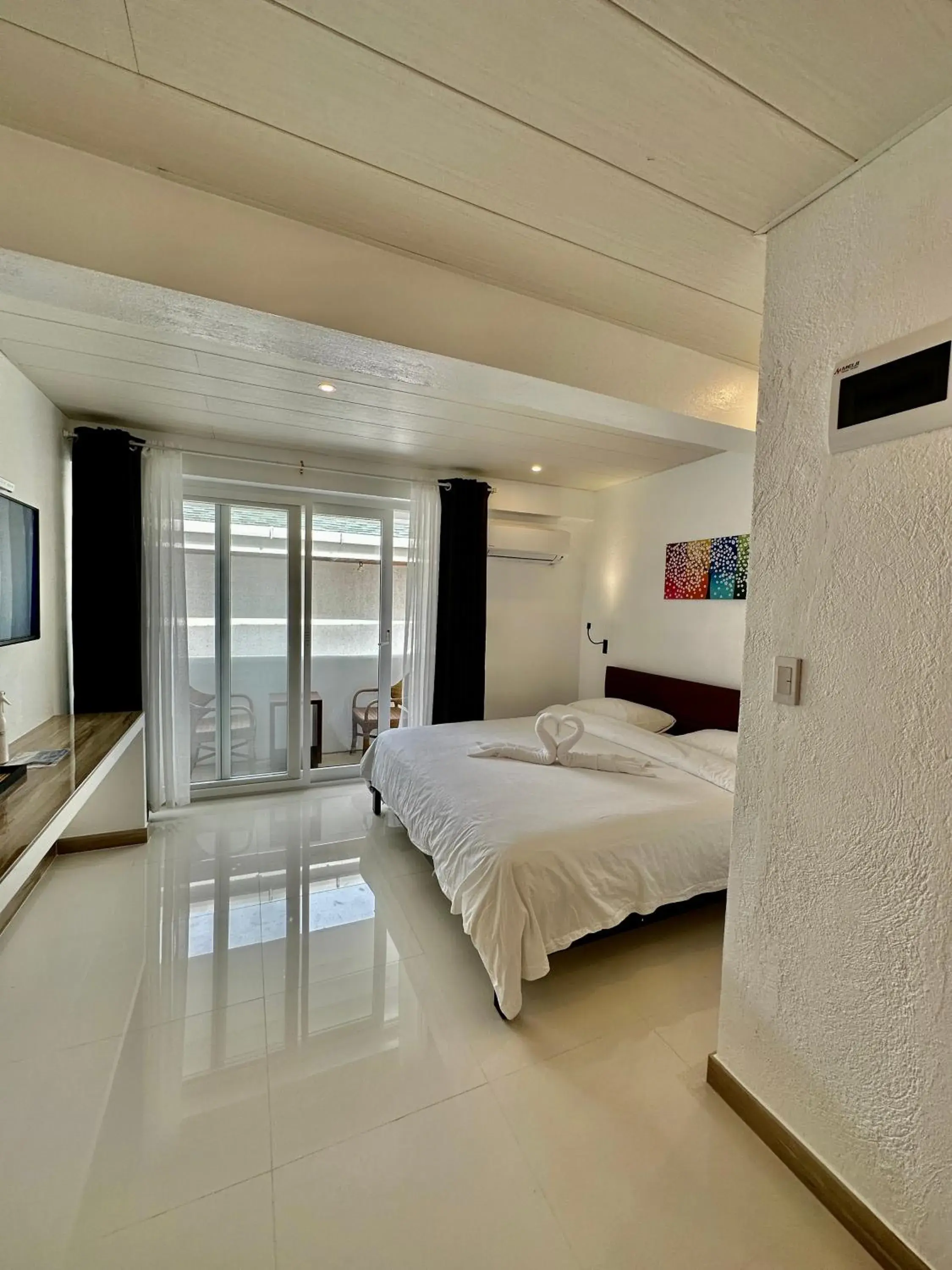 Photo of the whole room, Bed in Calypso Beach and Dive Resort Photo of the whole room, Bed in Calypso Beach and Dive Resort