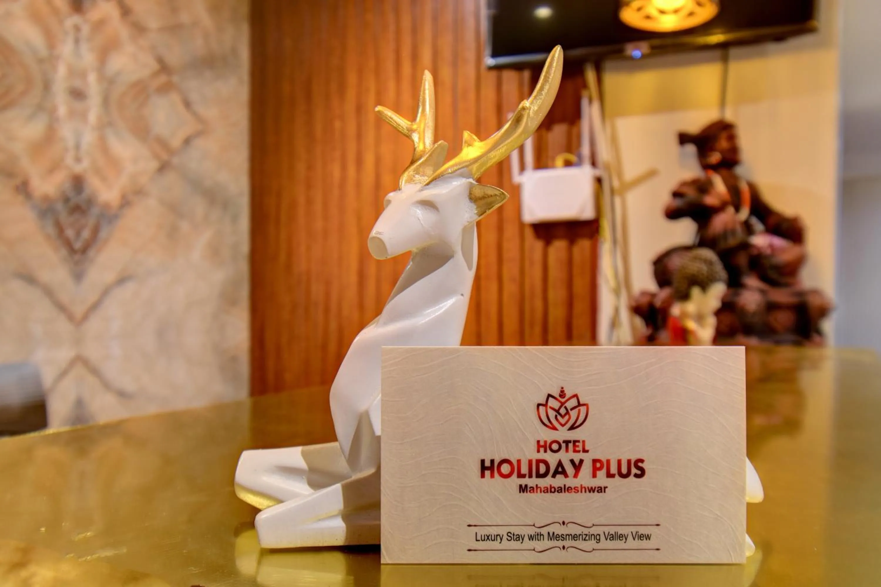 Property logo or sign in Holiday Plus
