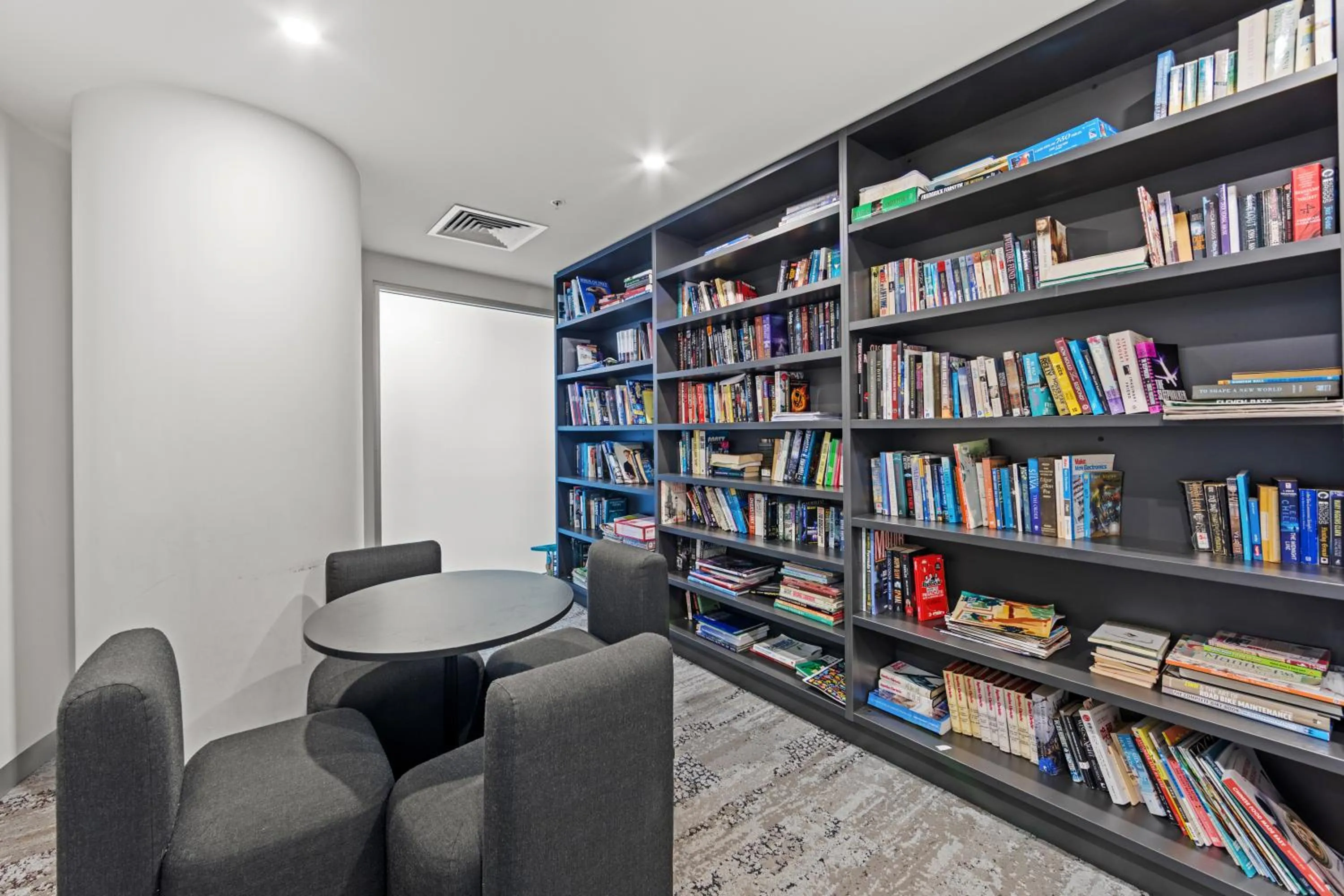 Library in Spire Residences by CLLIX