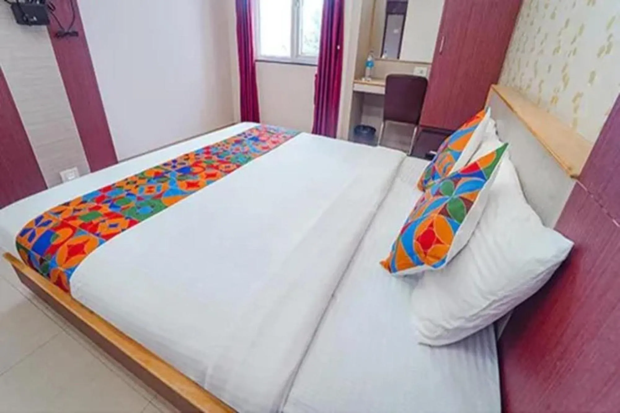Bed in FabHotel Grand Gunas