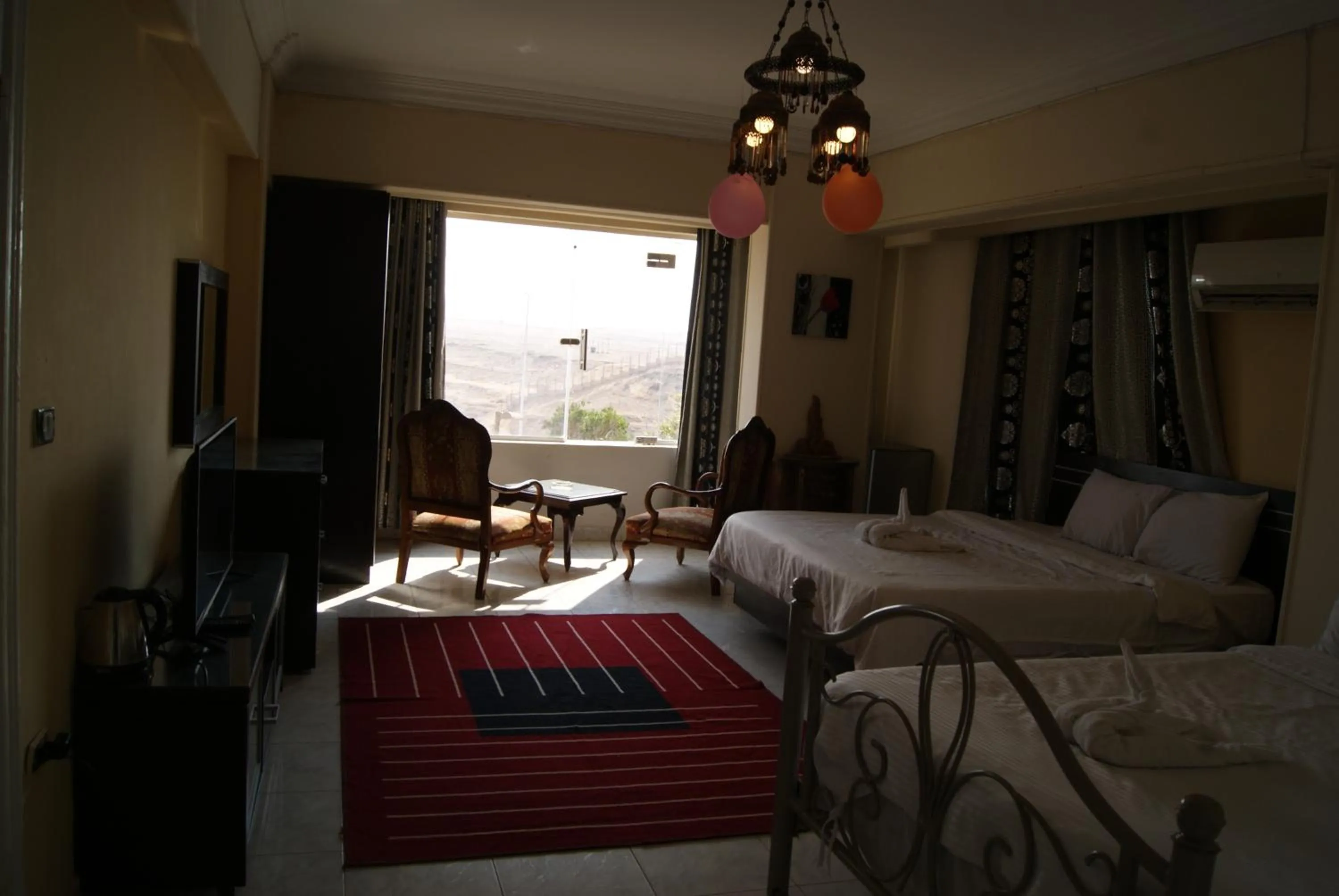 Photo of the whole room, Bed in Triangle Pyramids Boutique