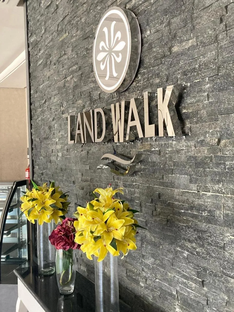 Property logo or sign in Land Walk Al Aqiq