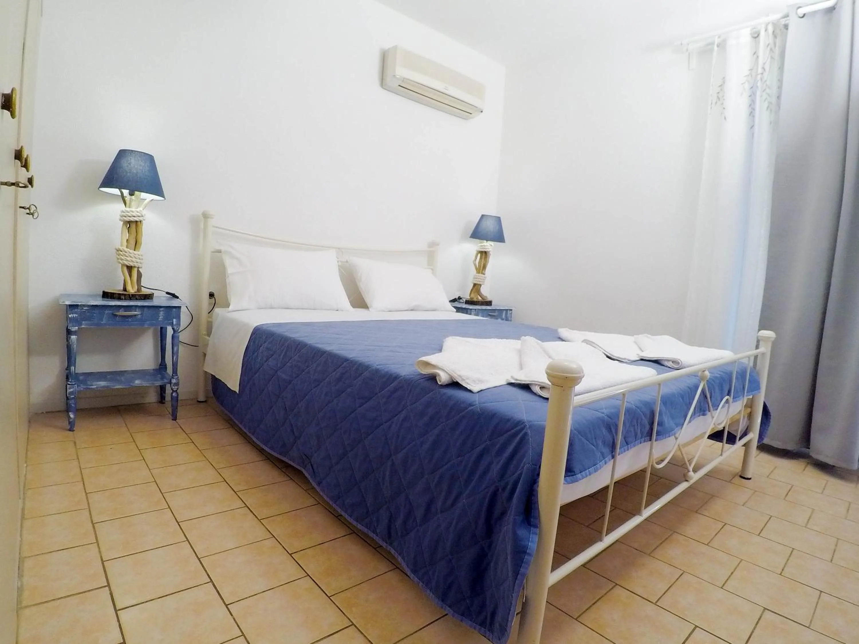 Bed in Blue Era Apartments