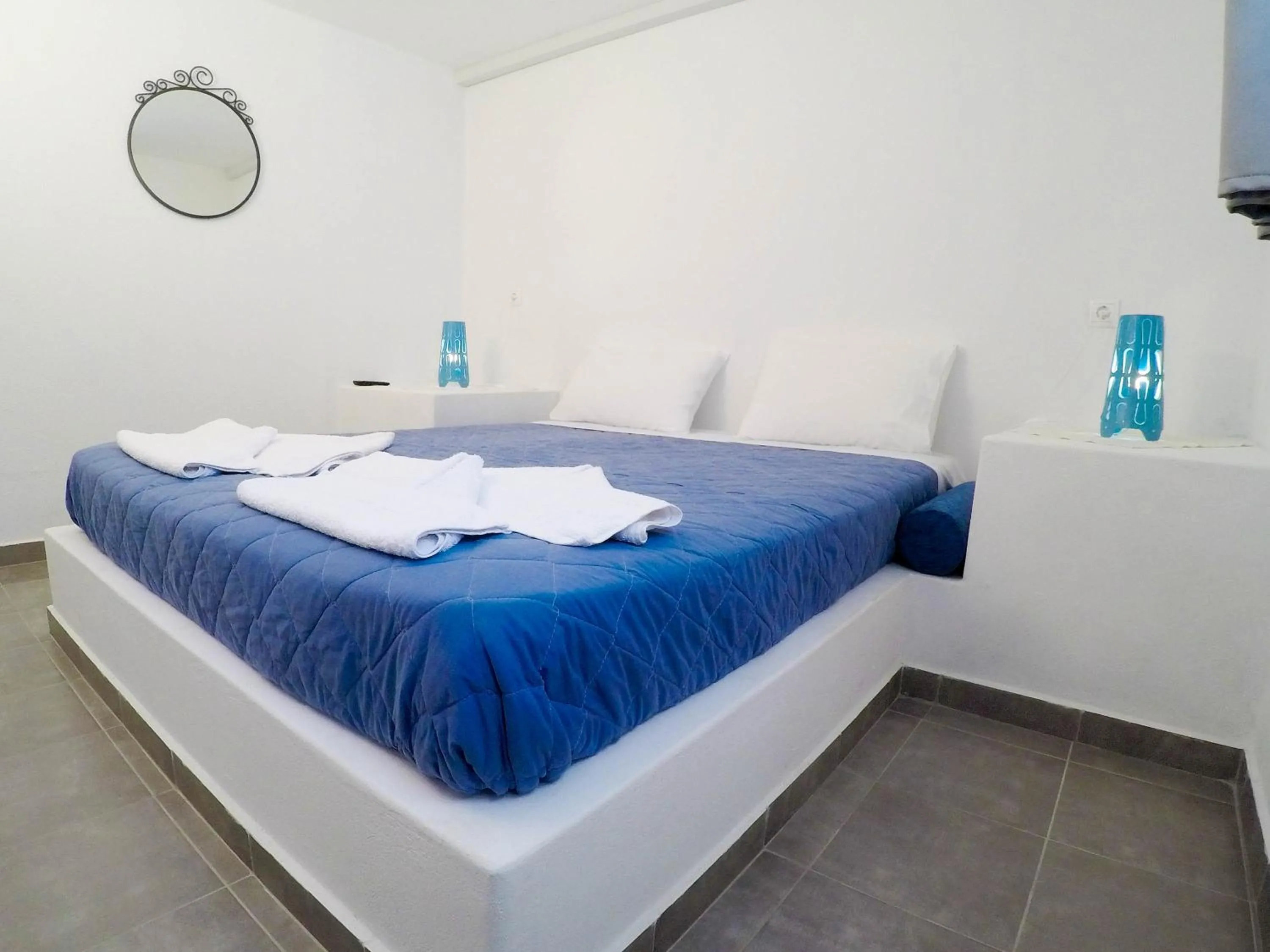 Bed in Blue Era Apartments