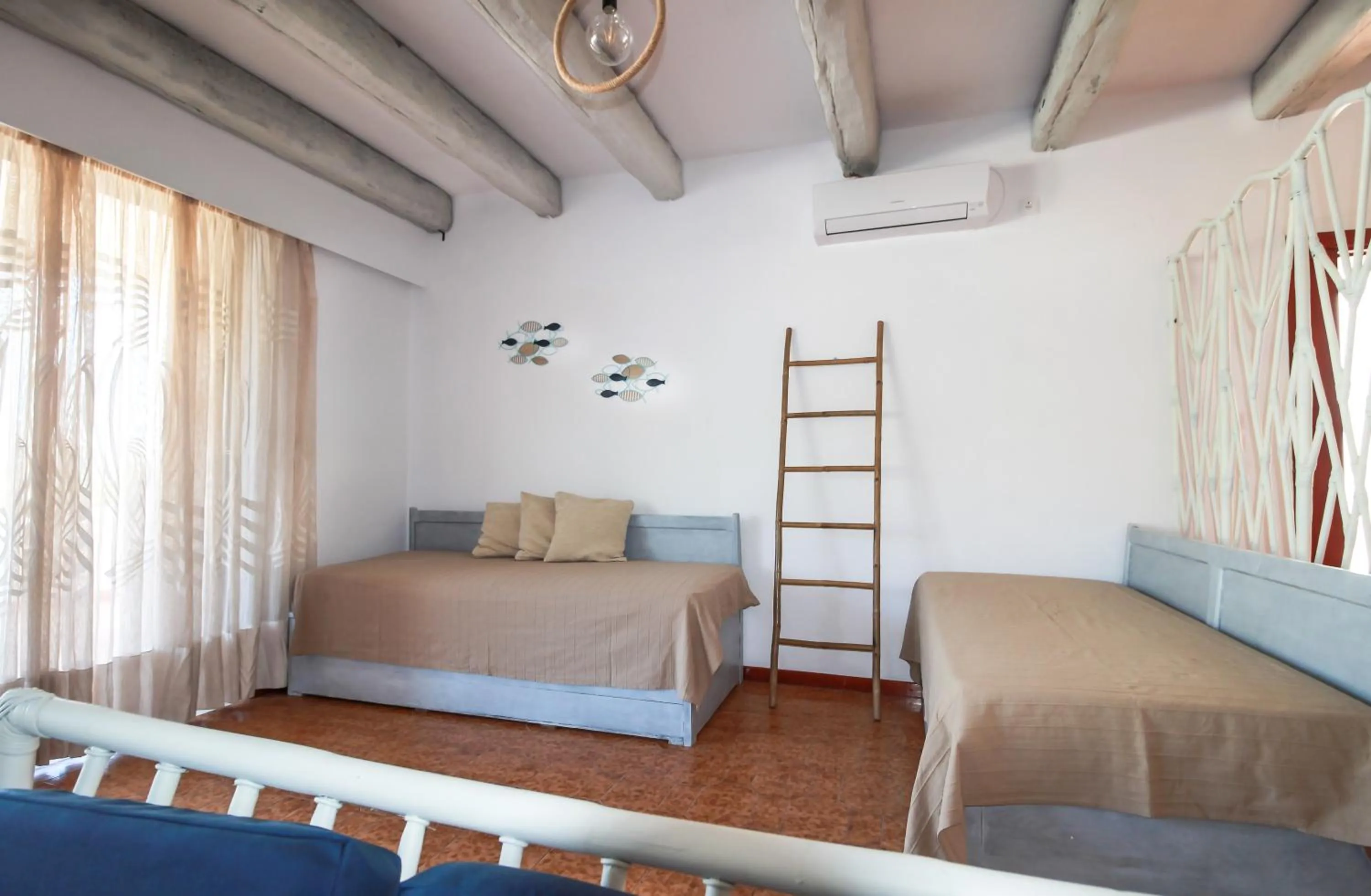 Bed in Blue Era Apartments