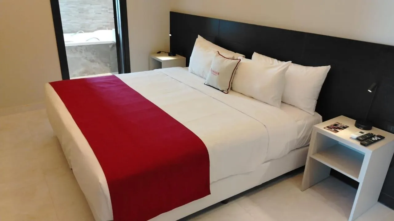 Bed in Ramada Suites by Wyndham Asuncion Aeropuerto