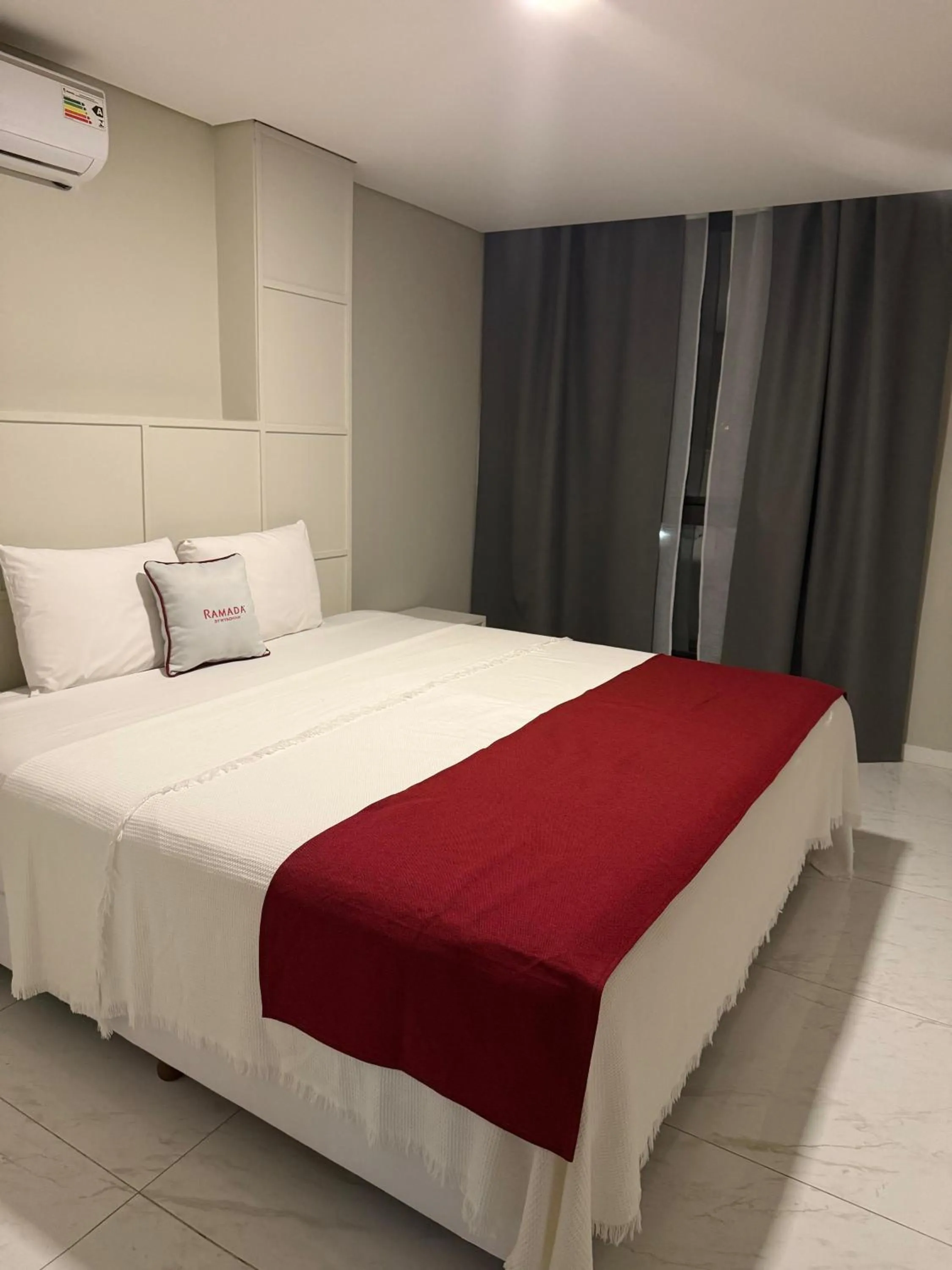 Bed in Ramada Suites by Wyndham Asuncion Aeropuerto