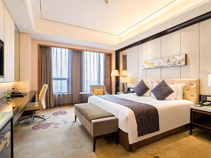 Bed in New Century Grand Hotel Siyang