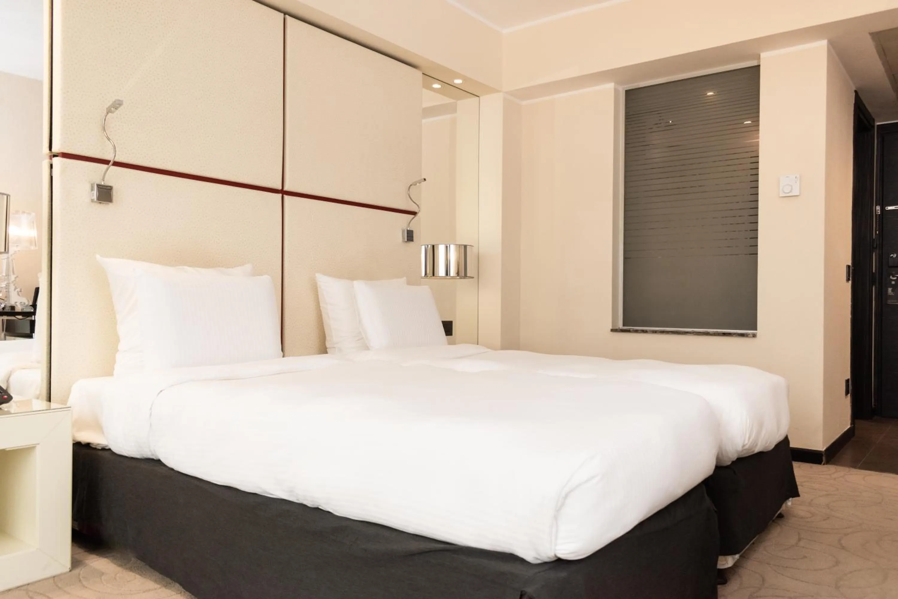 Bed in Pullman Kinshasa Grand Hotel