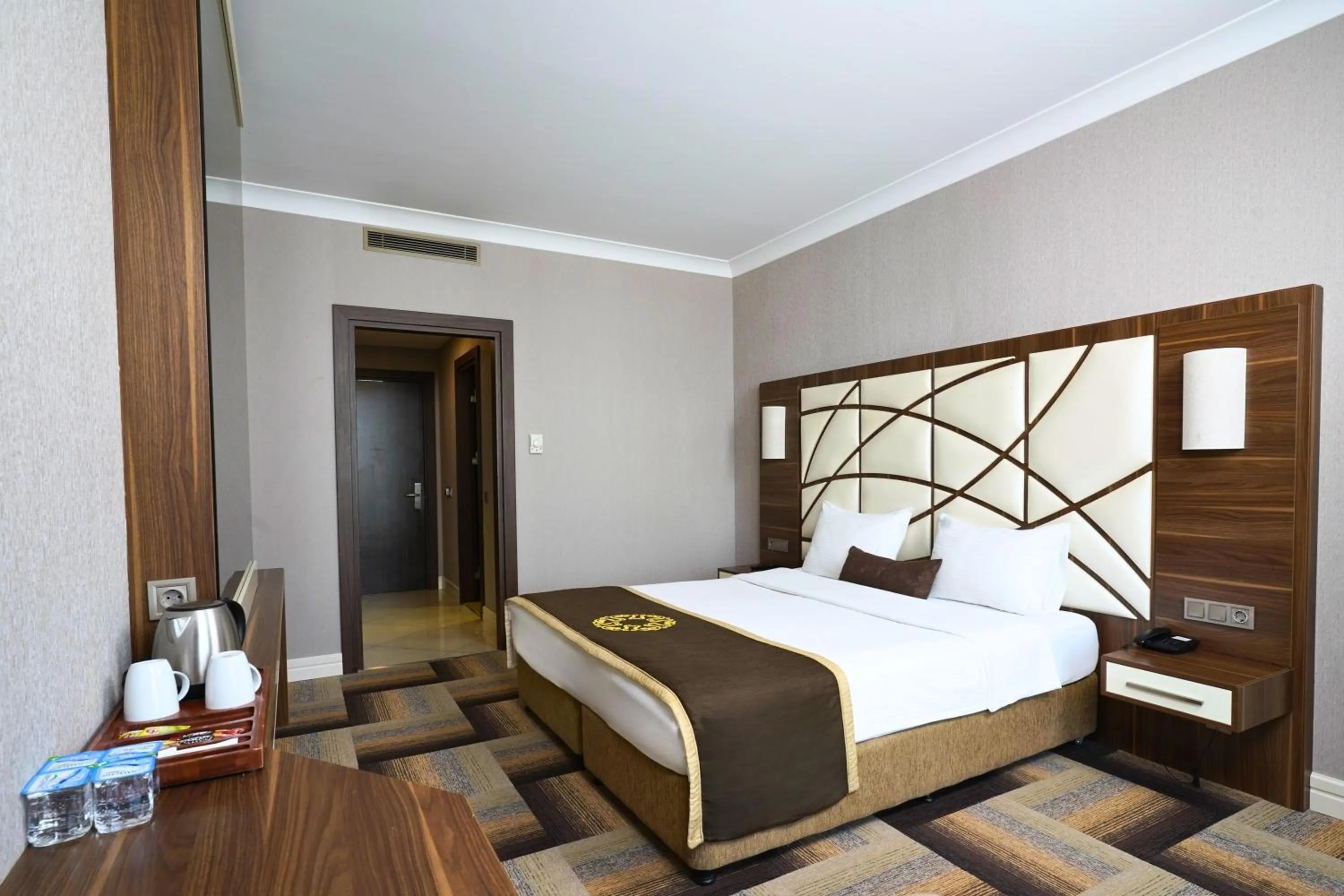 Bed in The Grand Mira Business Hotel