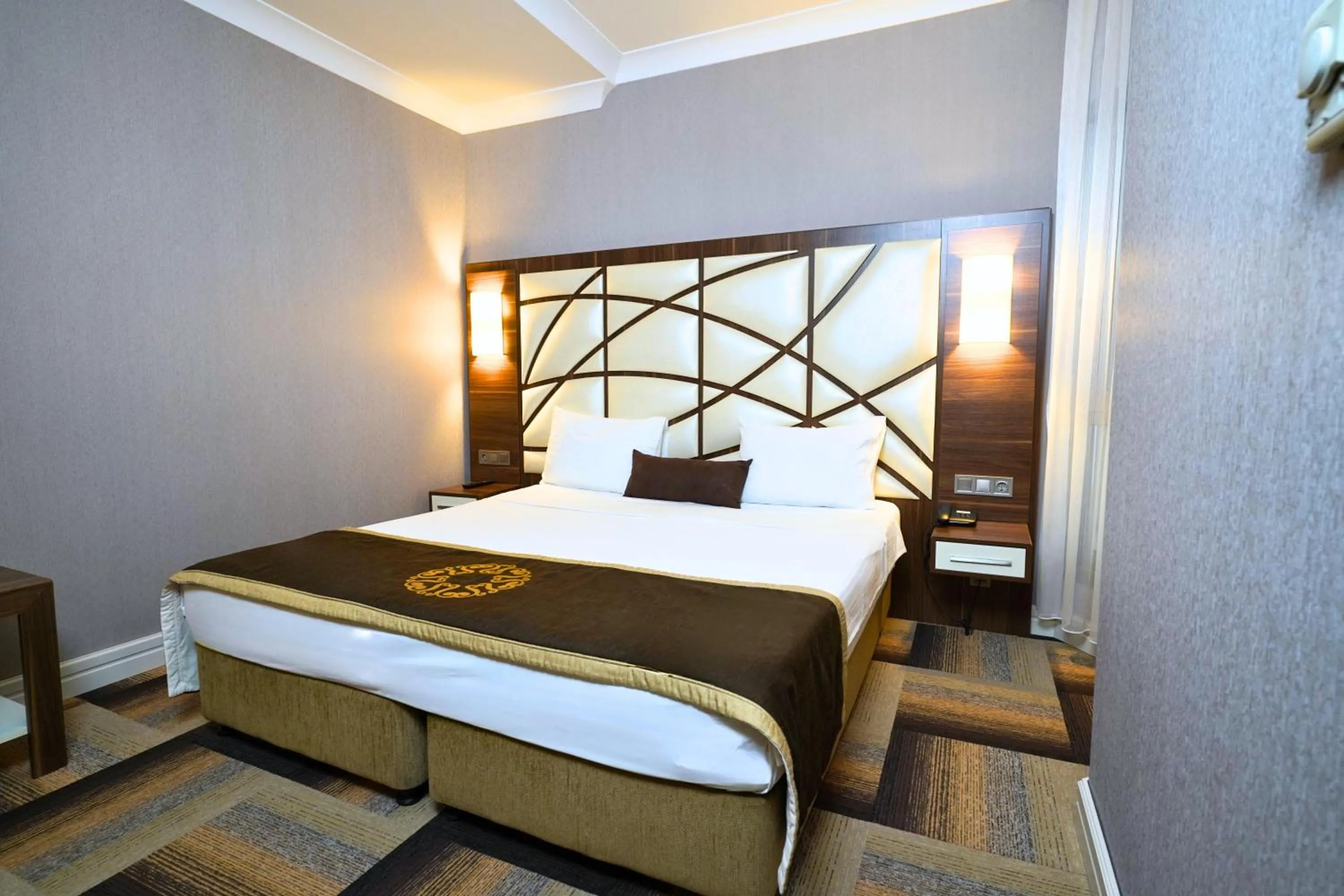 Bed in The Grand Mira Business Hotel