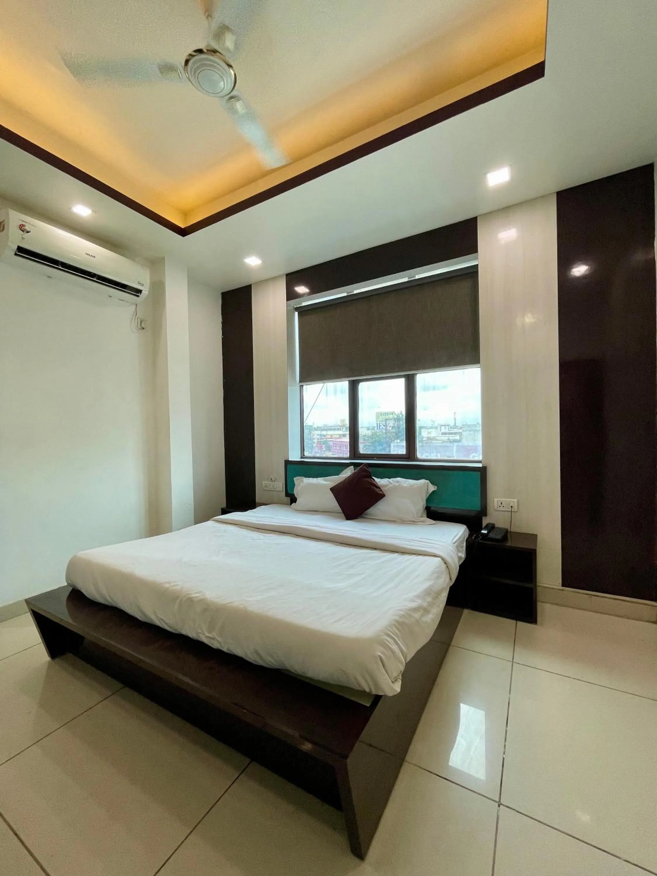 Photo of the whole room, Bed in Hotel Komal Palace Anand Nagar