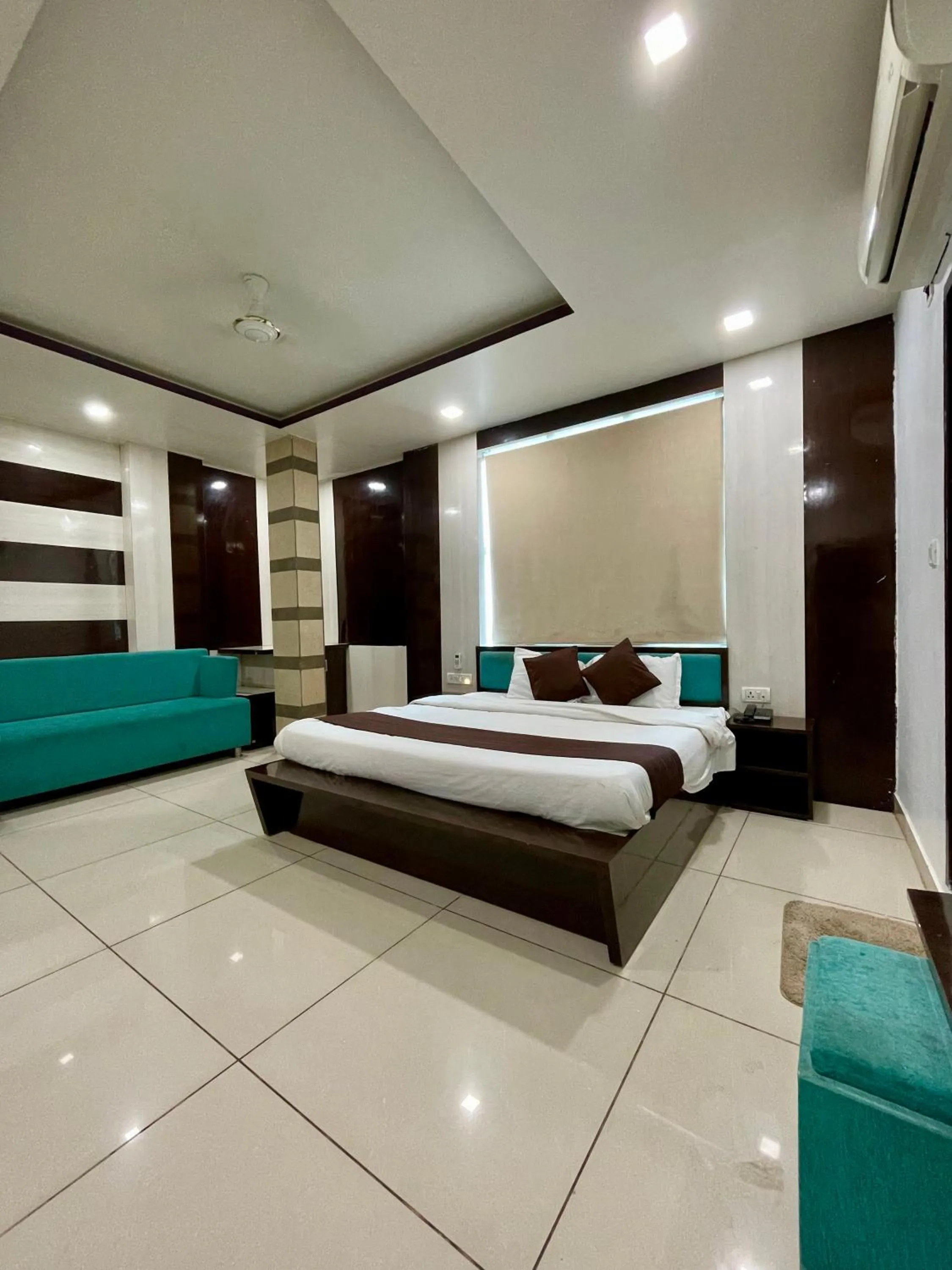 Photo of the whole room, Bed in Hotel Komal Palace Anand Nagar