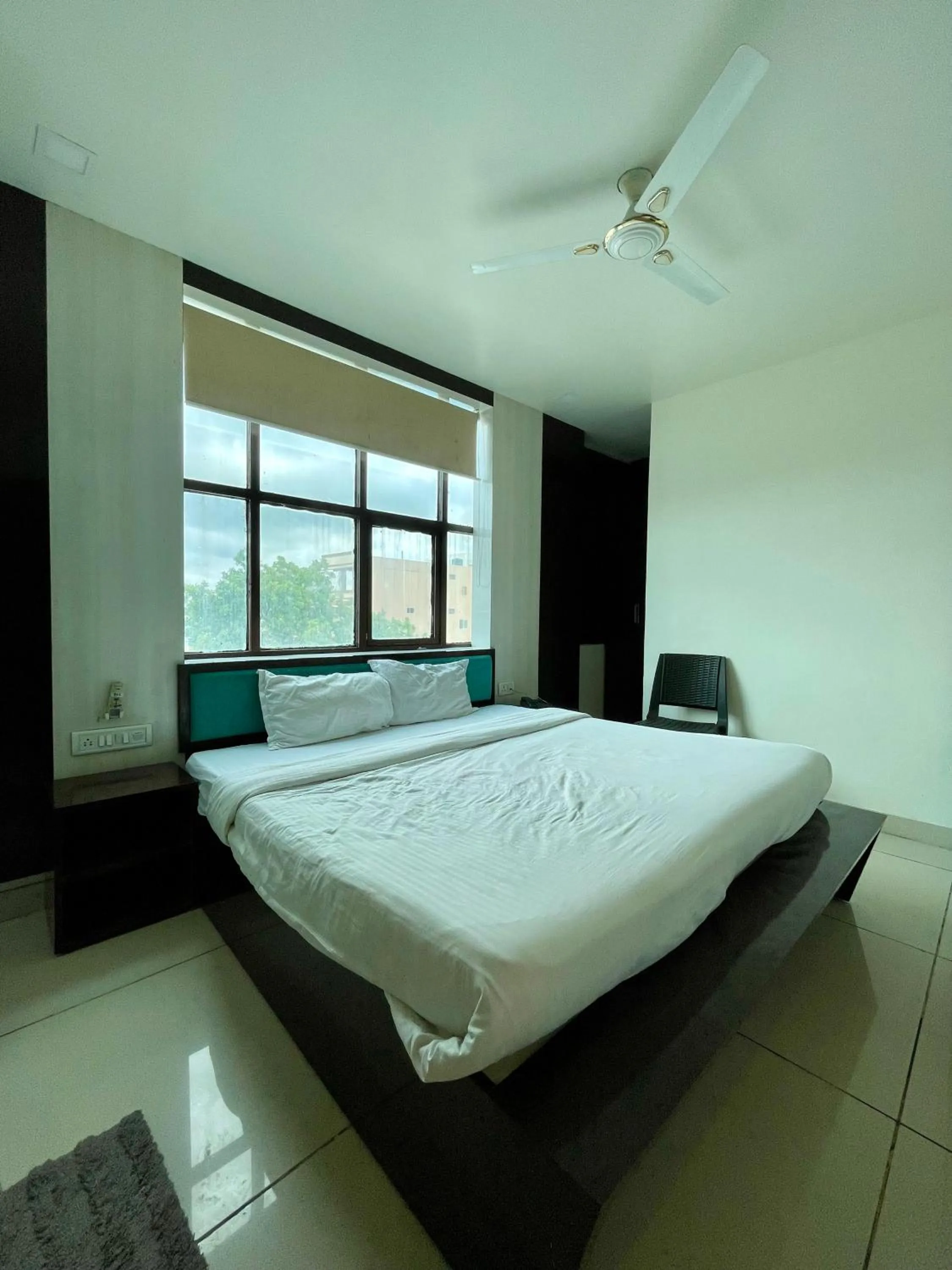 Photo of the whole room, Bed in Hotel Komal Palace Anand Nagar