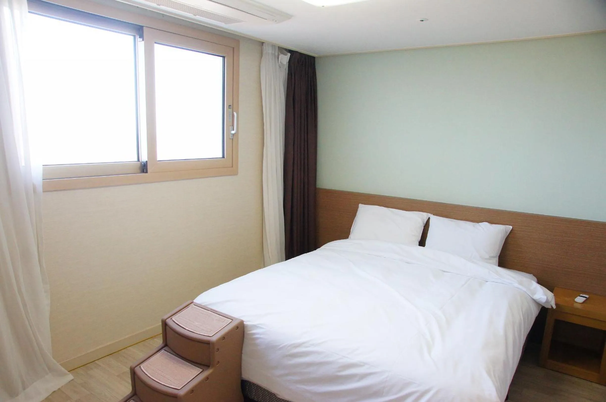 Bed in Hi Jeju Hotel