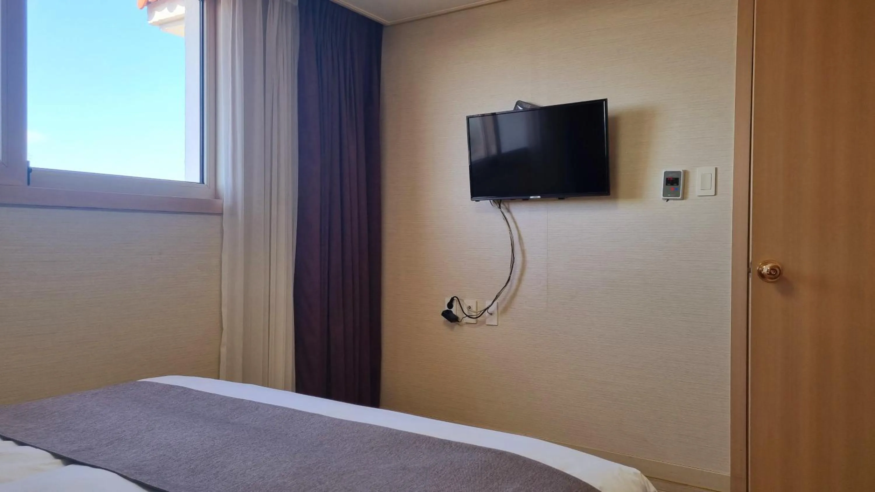 Bed in Hi Jeju Hotel