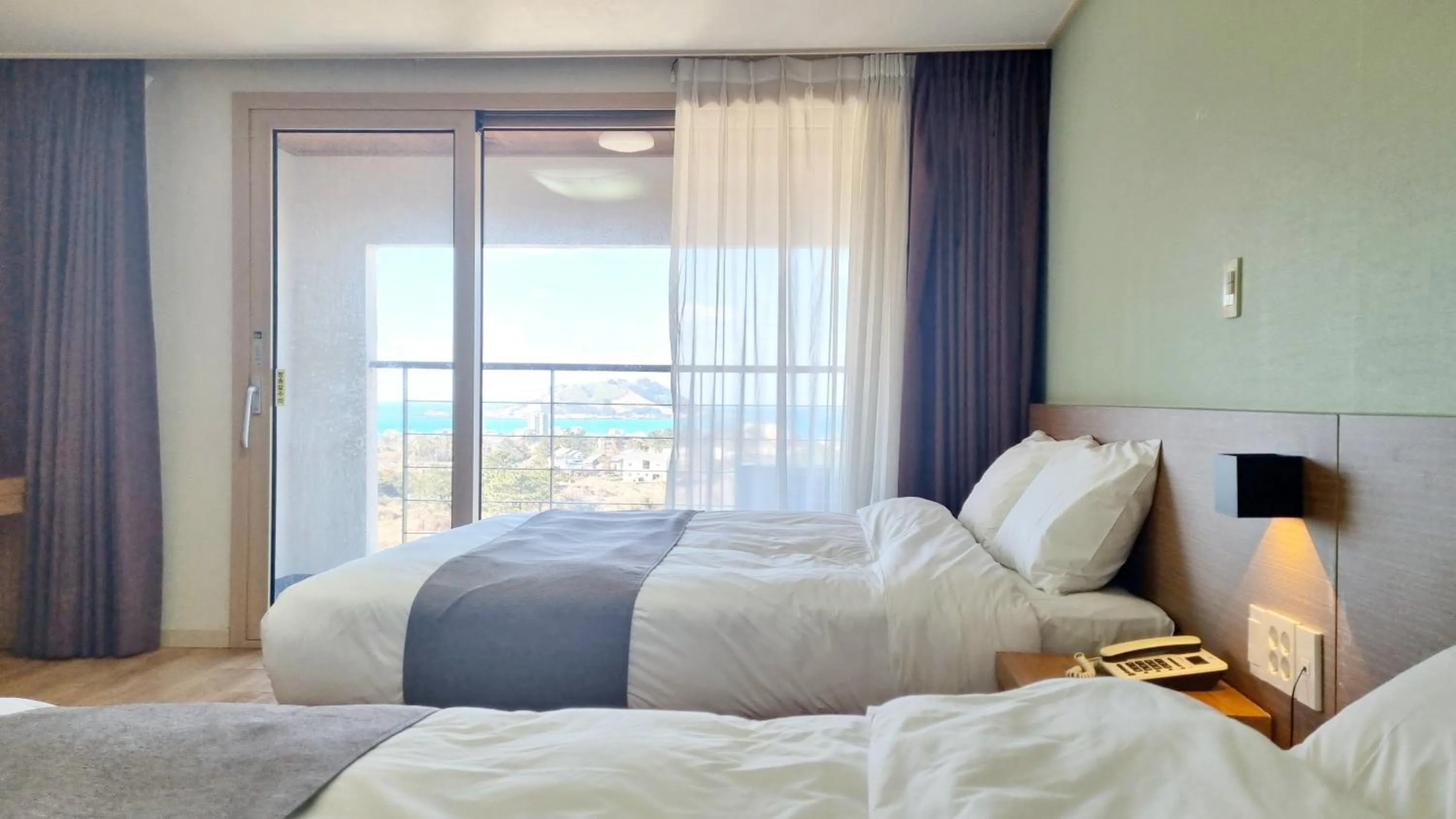 Bed in Hi Jeju Hotel