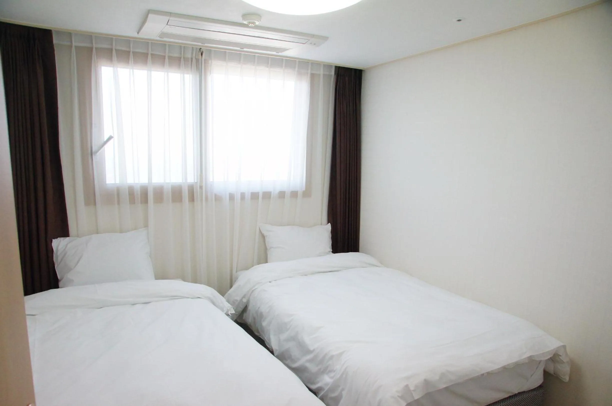 Bed in Hi Jeju Hotel