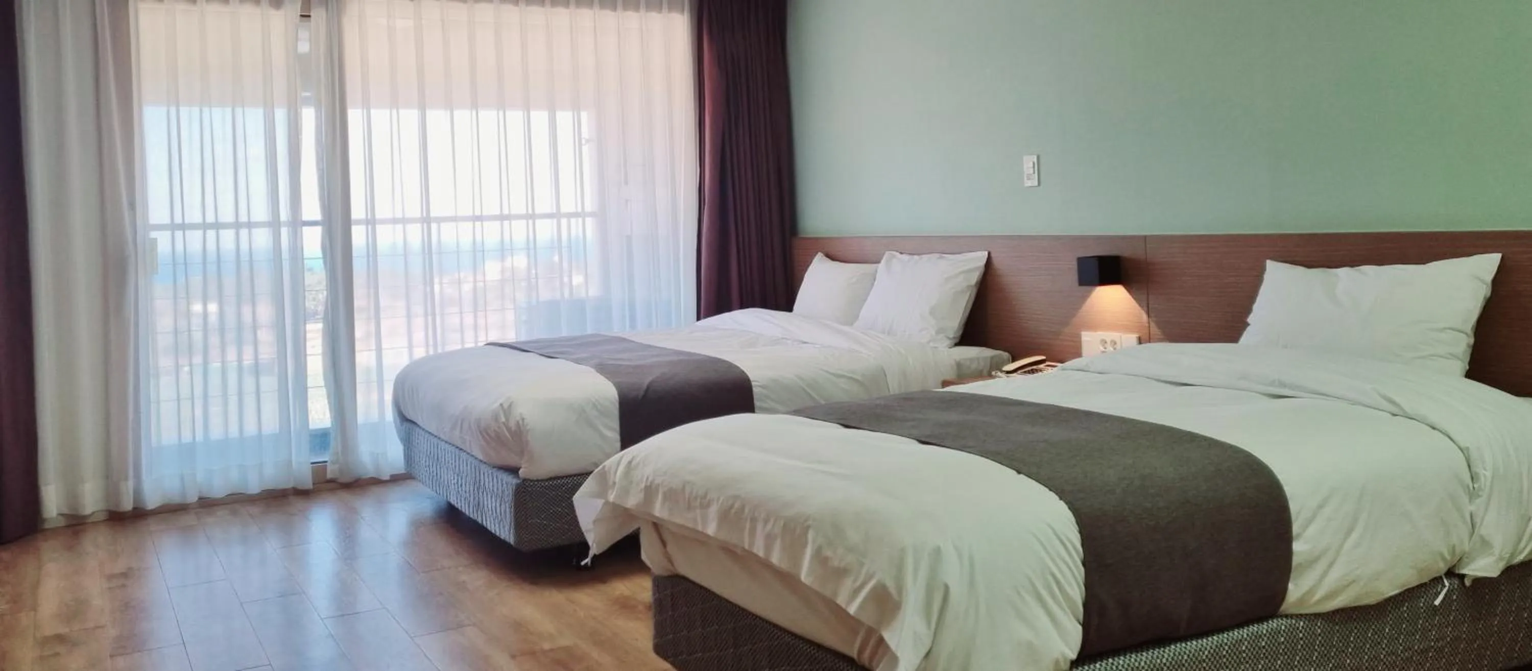 Bed in Hi Jeju Hotel