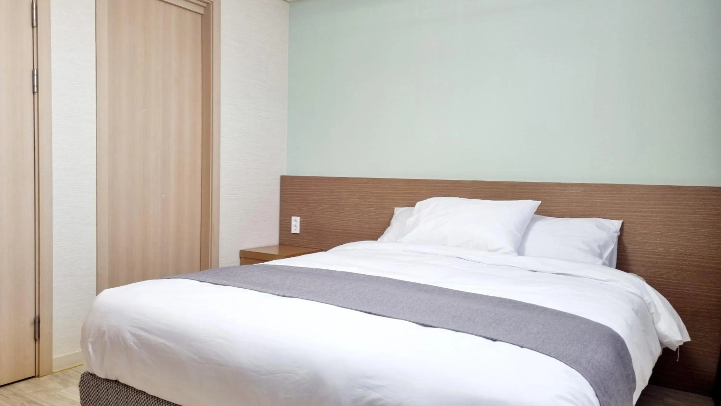 Bed in Hi Jeju Hotel