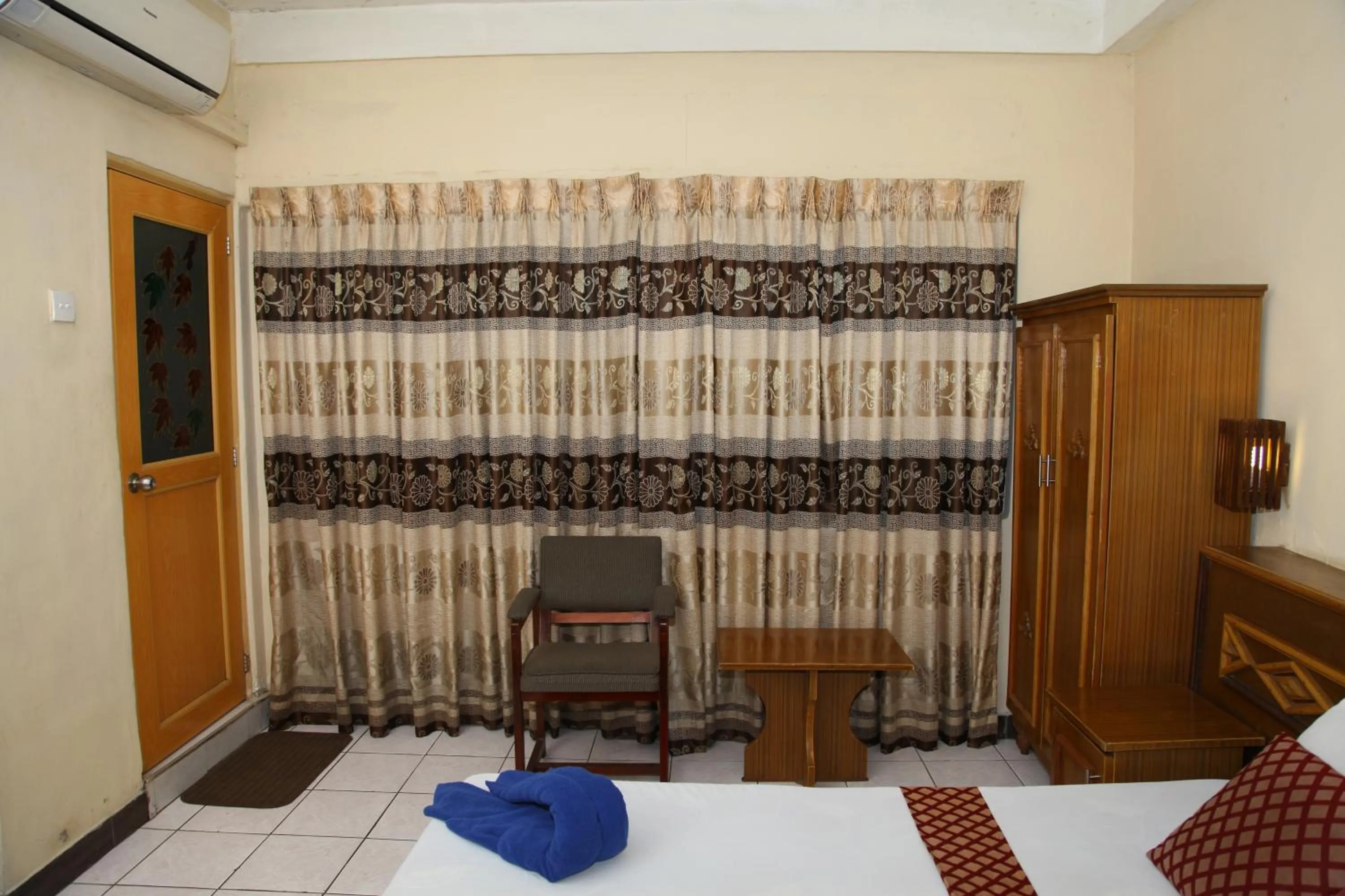 Seating area, Bed in Brighten Hotel