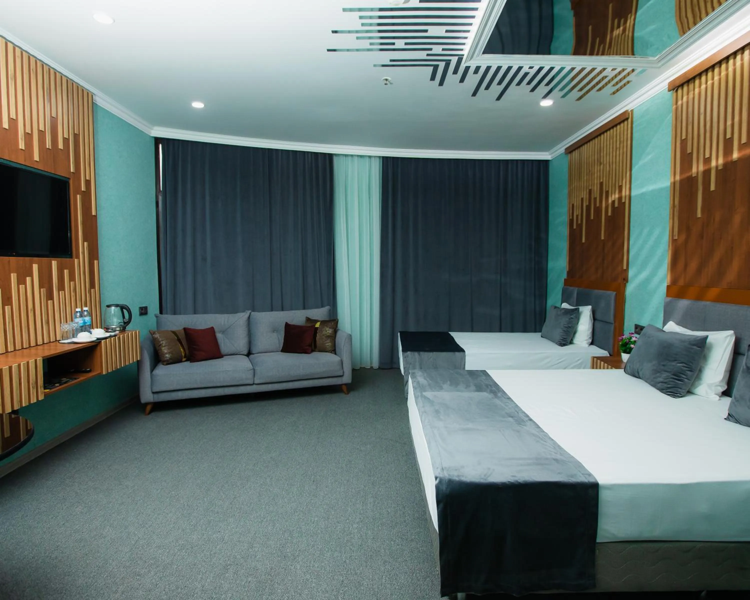 Communal lounge/ TV room, Bed in Corniche White City Hotel