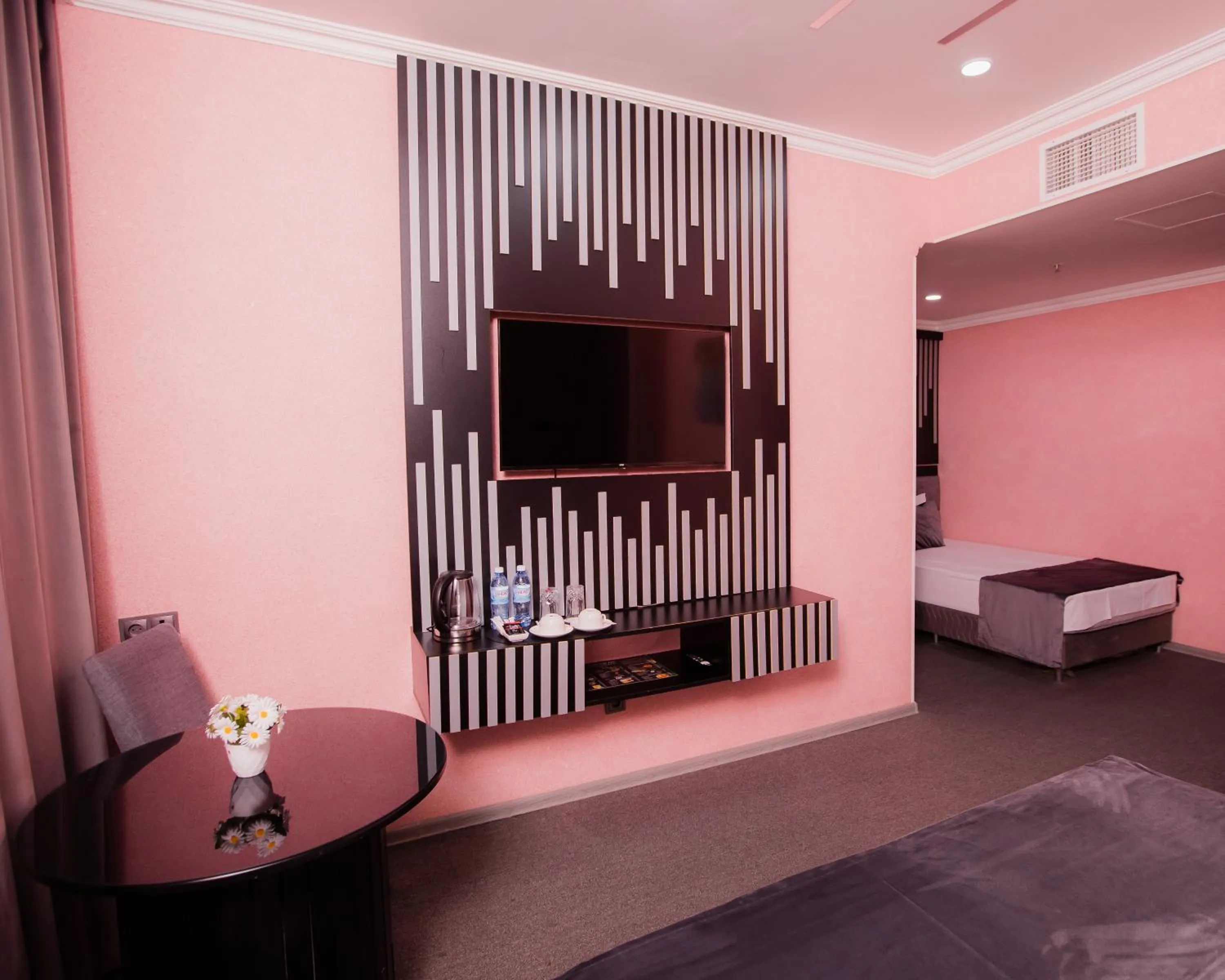 Communal lounge/ TV room, Bed in Corniche White City Hotel
