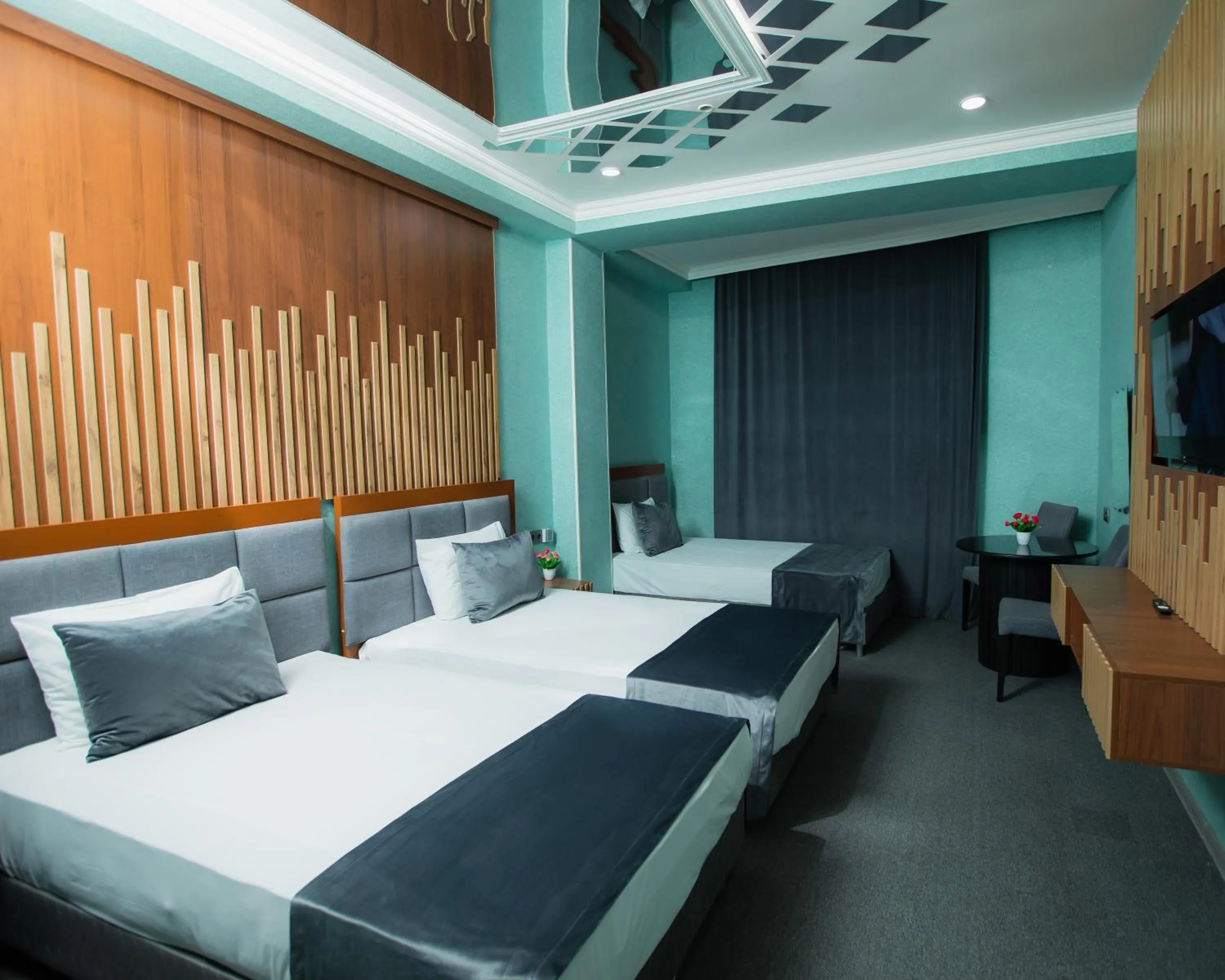 Communal lounge/ TV room, Bed in Corniche White City Hotel