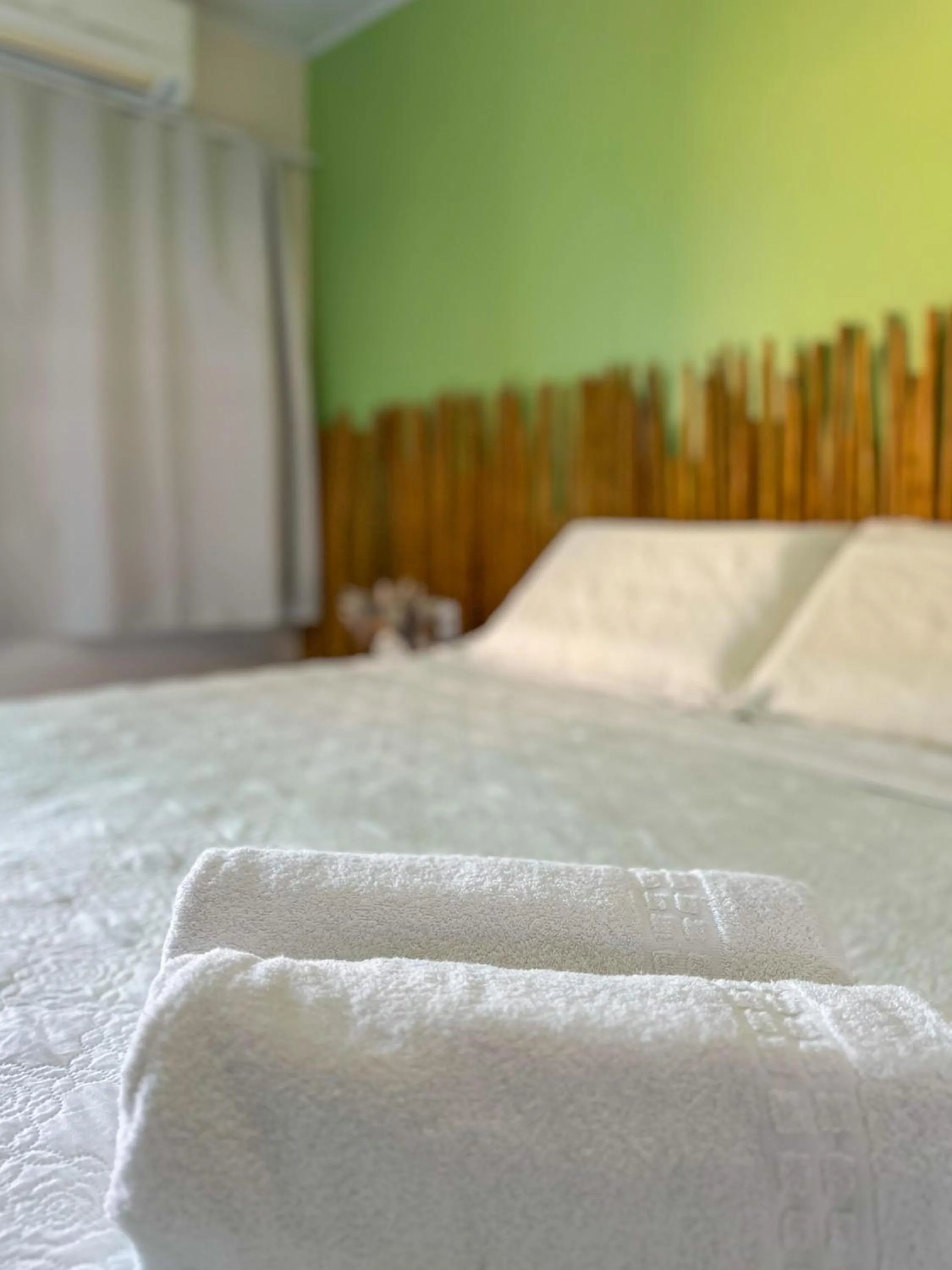 Bed in Pousada Camburi