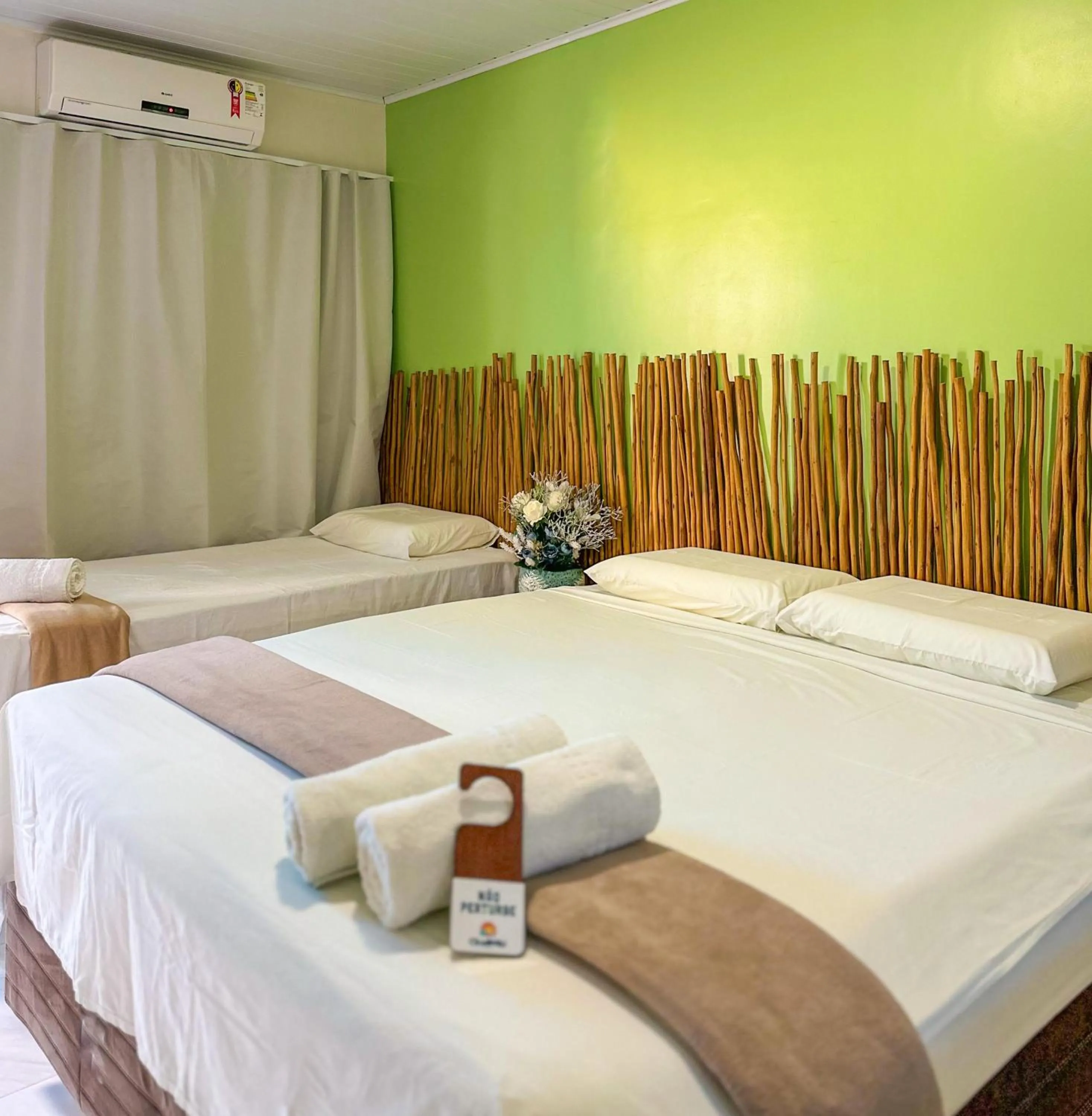 Bed in Pousada Camburi