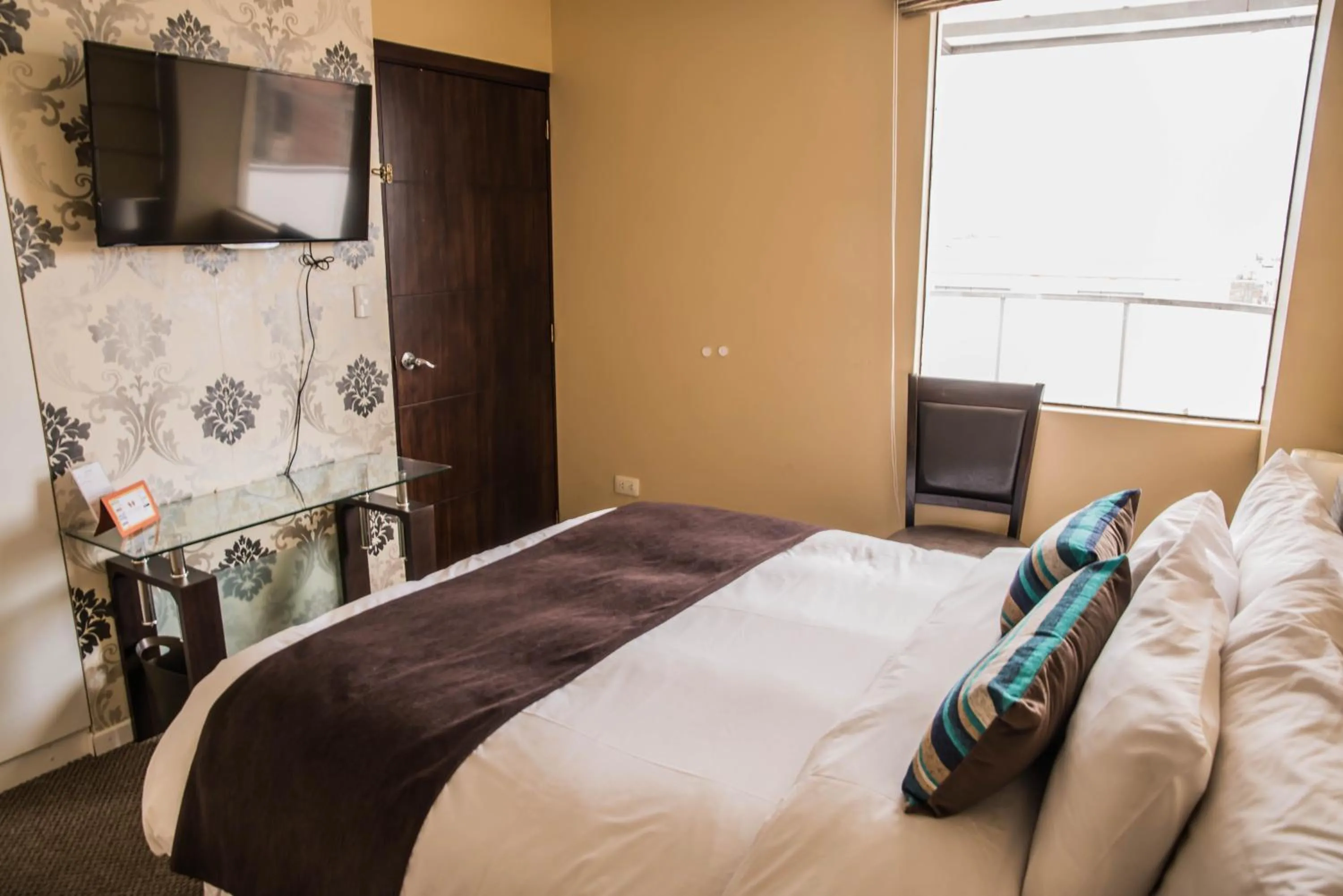 Bed in Los Leones Hotel Boutique
