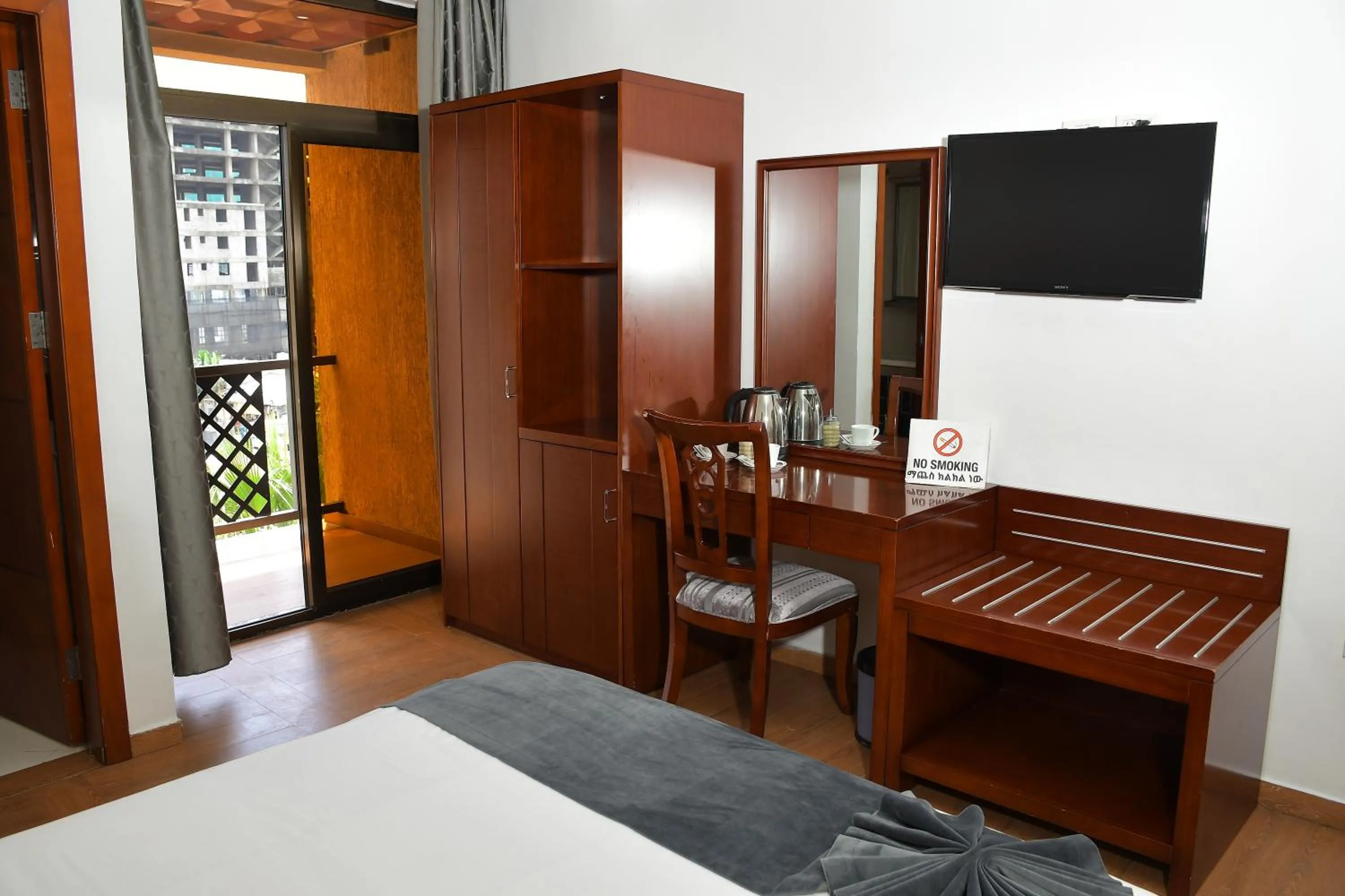 Communal lounge/ TV room, Bed in Sun View Hotel