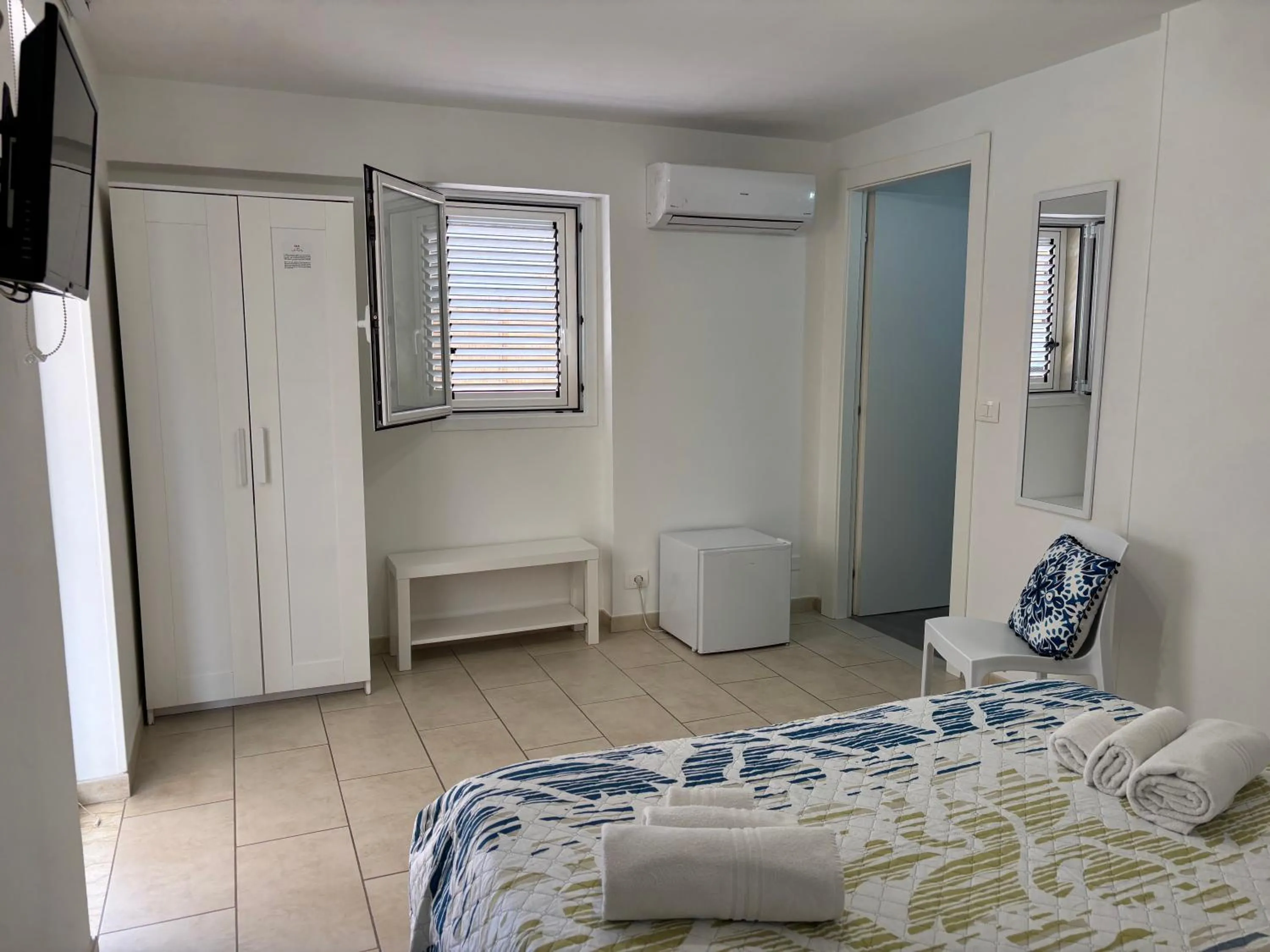 Bed in Le Torrette Rooms and Apartments