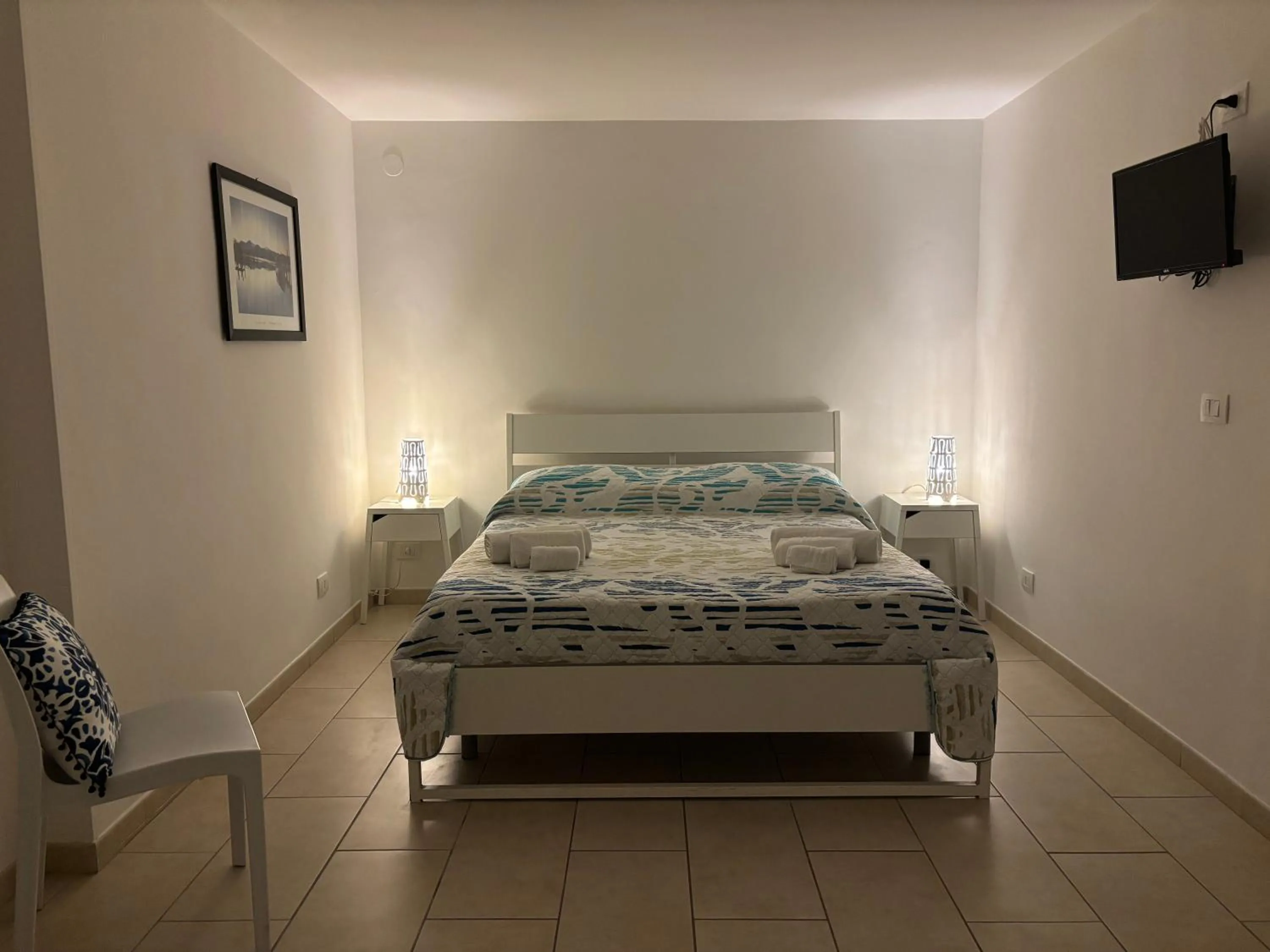 Bed in Le Torrette Rooms and Apartments