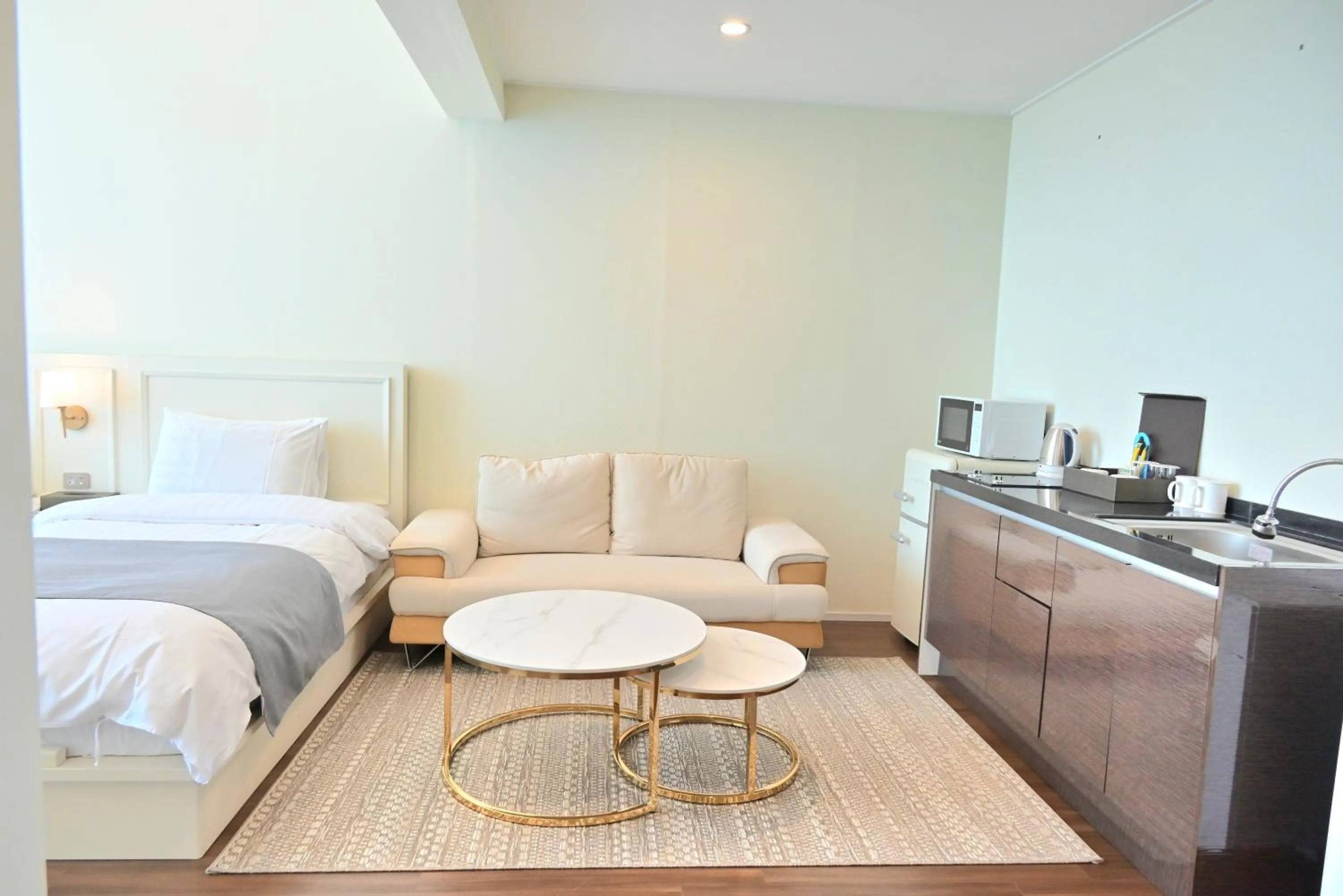 Seating area, Bed in Rich Hotel