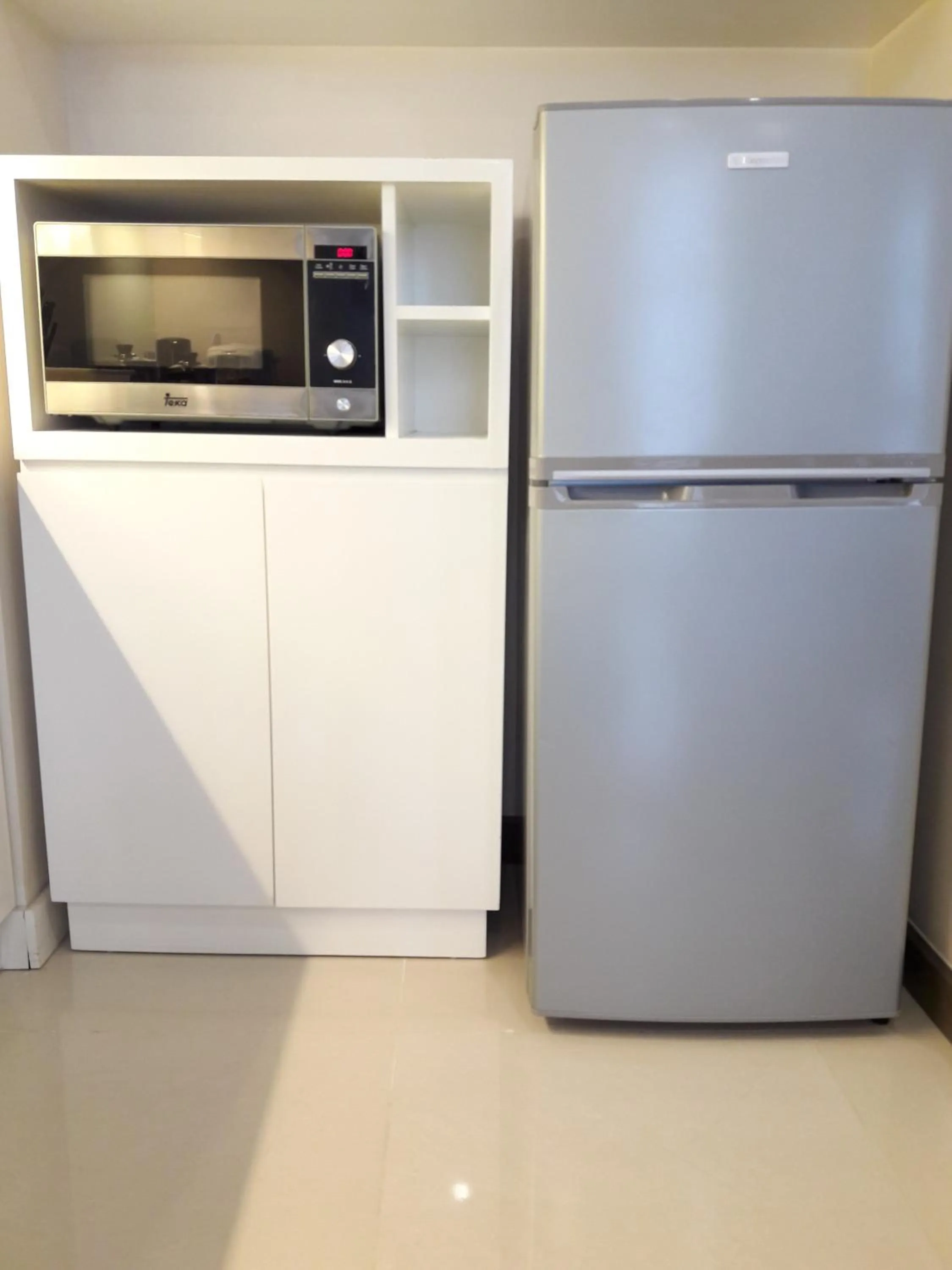 Kitchen or kitchenette in Bluesky Serviced Apartment Airport Plaza