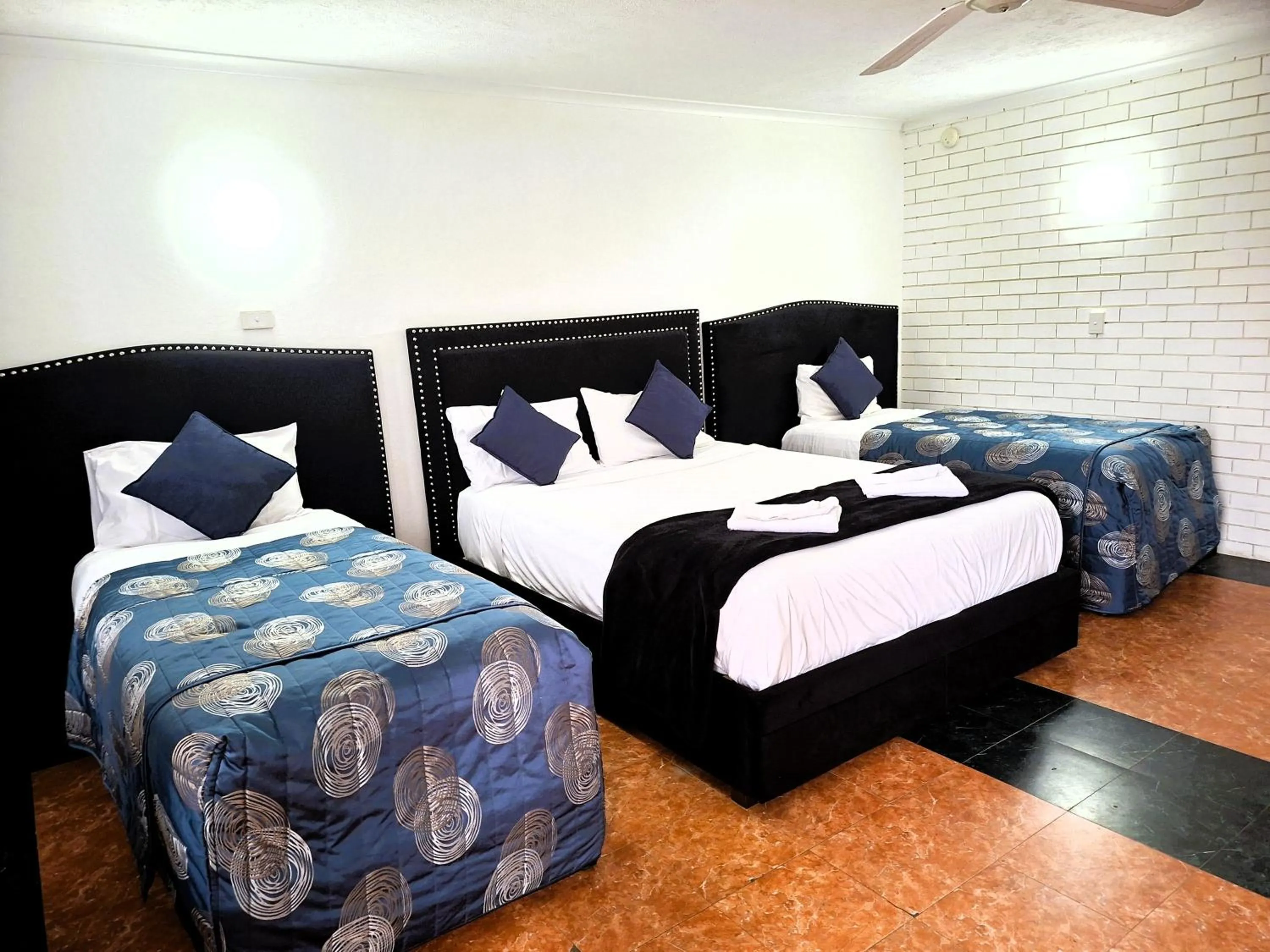 Bed in The Queenslander Motel