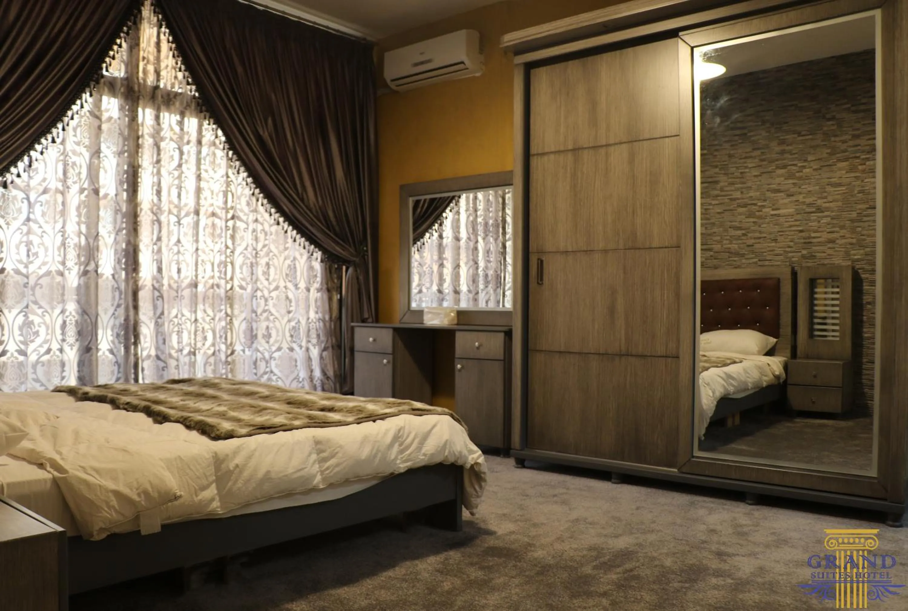 Bed in Grand Suites Hotel