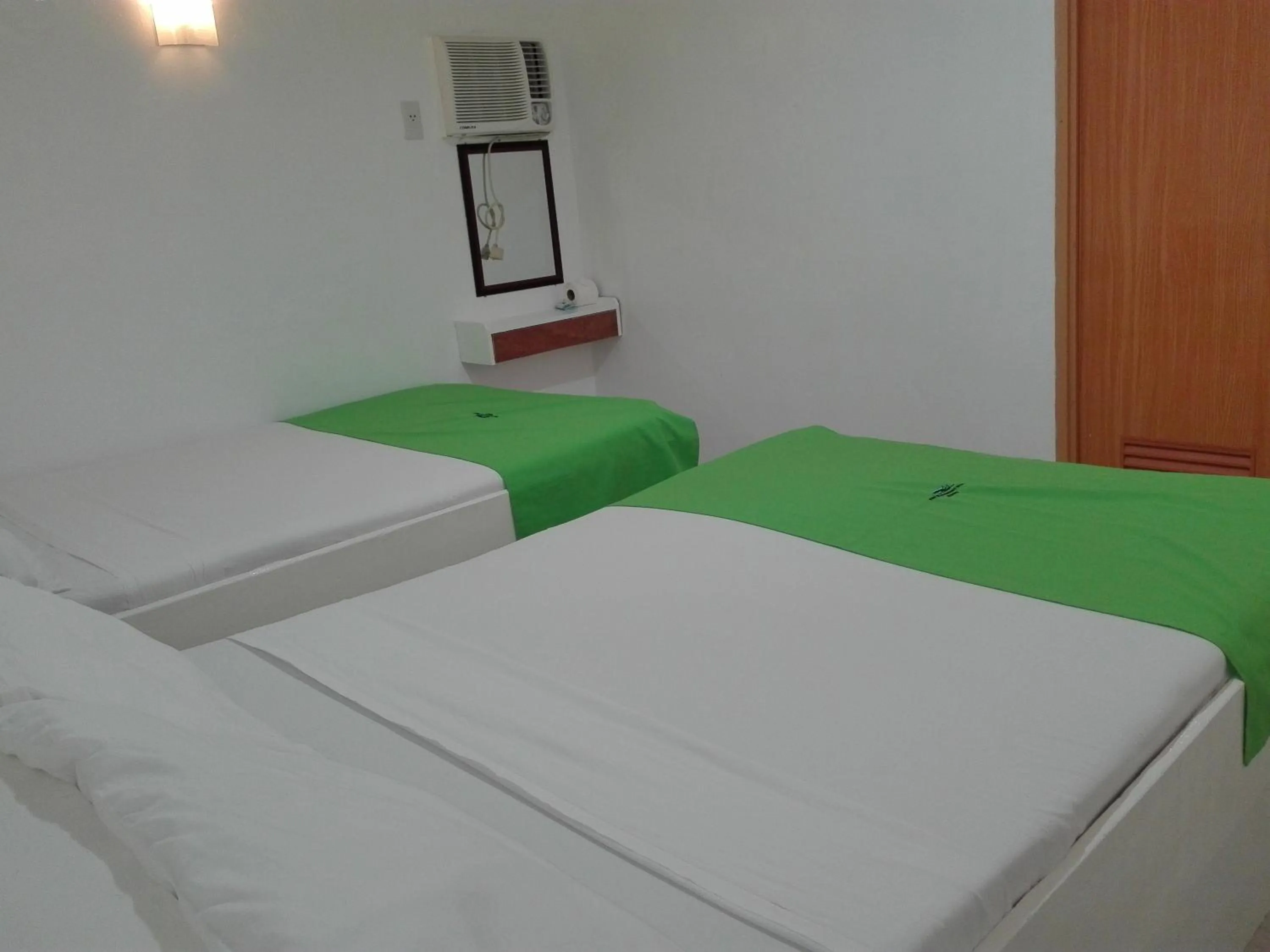 Bed in The Waterfront Beach Resort