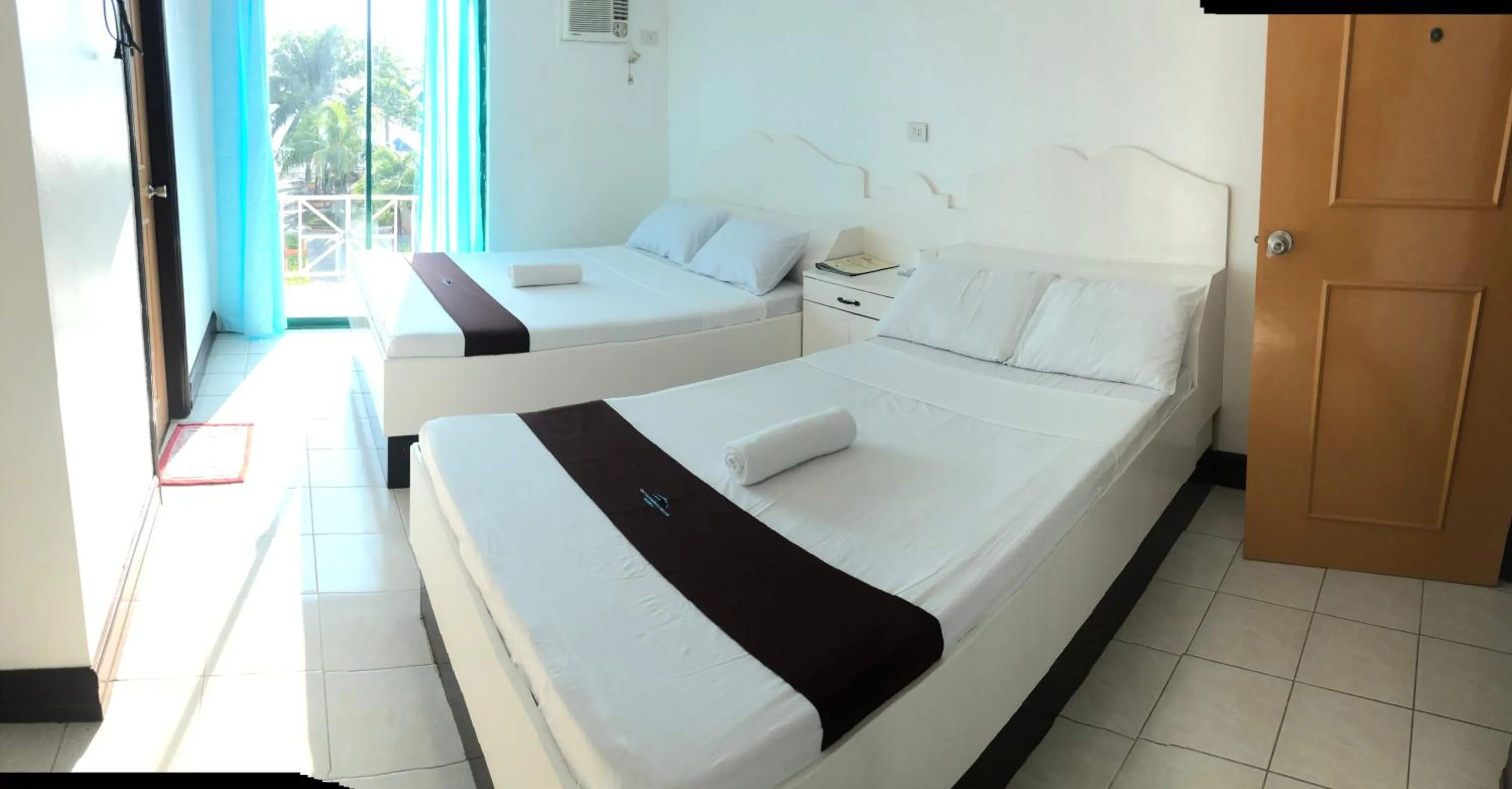 Bed in The Waterfront Beach Resort