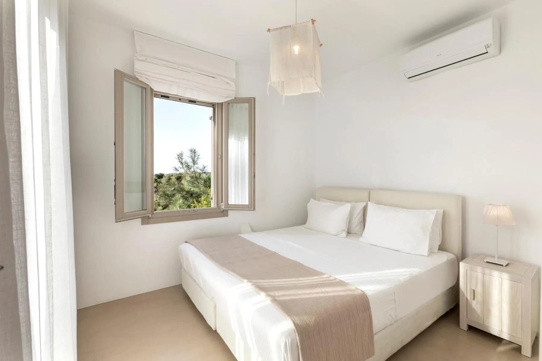 Bed in White Tinos Luxury Suites