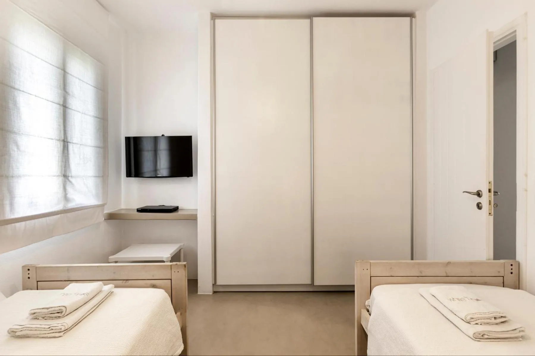 Bed in White Tinos Luxury Suites