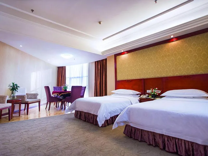 Bed in Vienna International Hotel Shenzhen Songgang Wanzhao Square