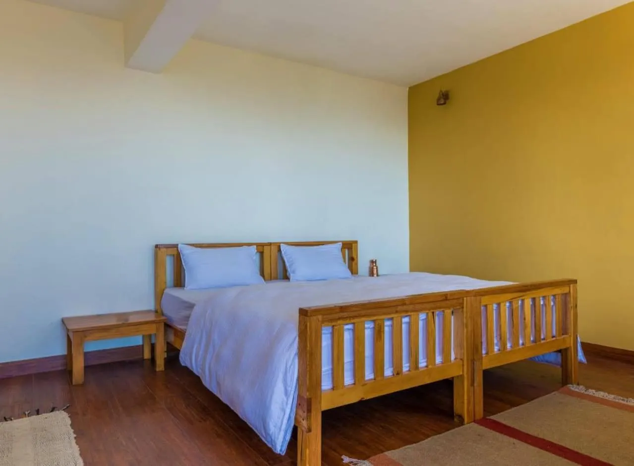 Photo of the whole room, Bed in Kasar Rainbow Yoga Retreat