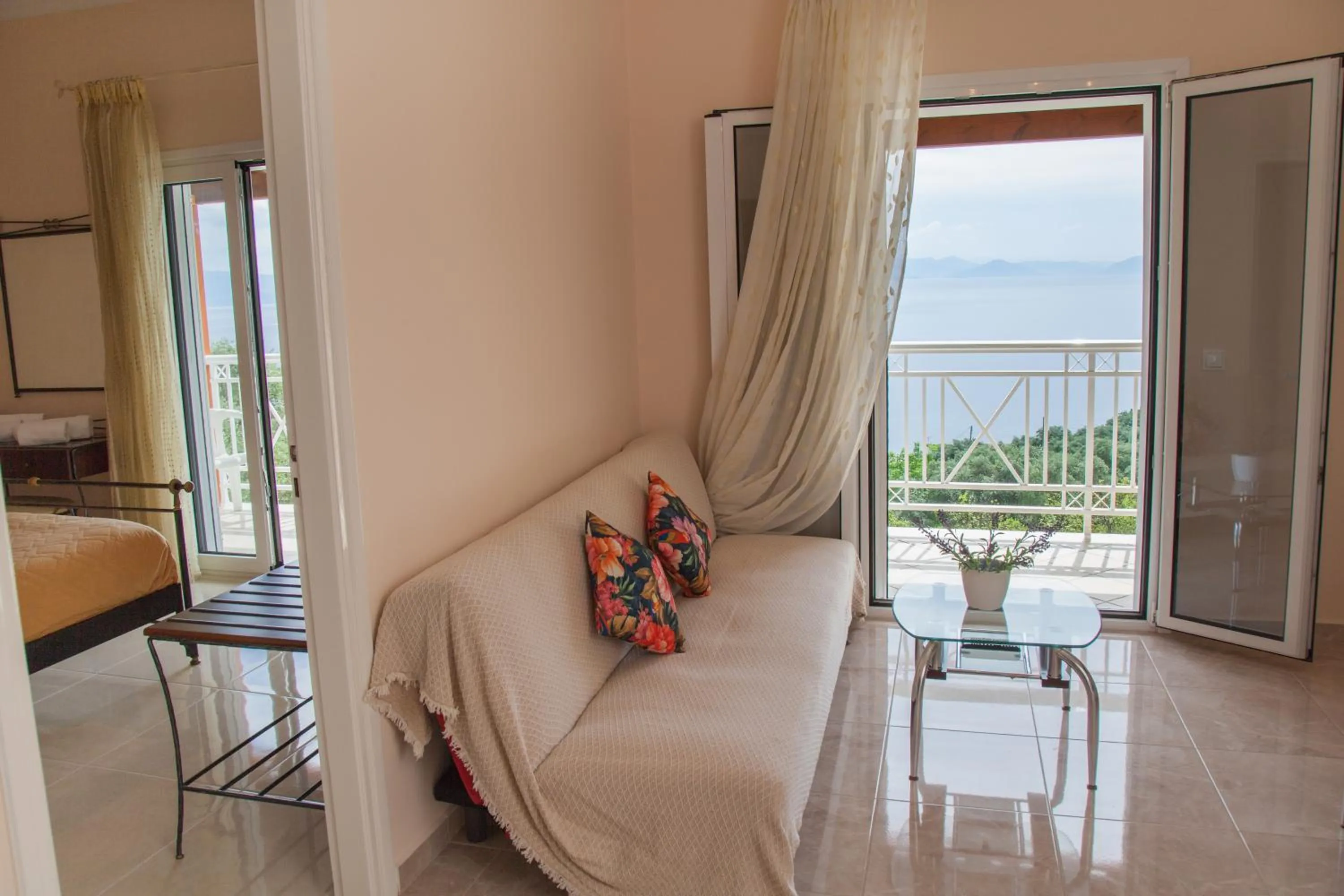 Living room, Bed in Brentanos Apartments - A - View of Paradise