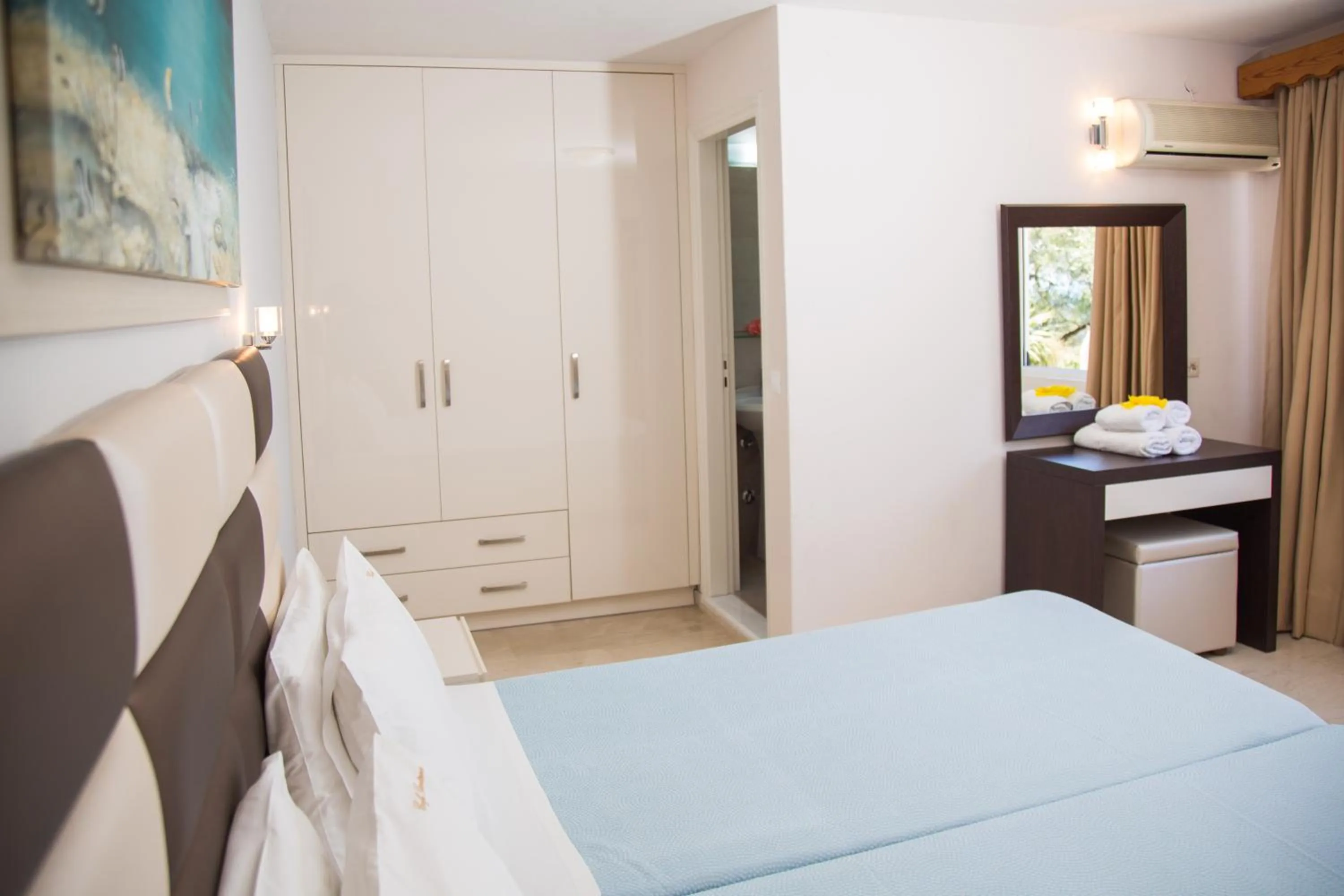 Bed in Brentanos Apartments - A - View of Paradise