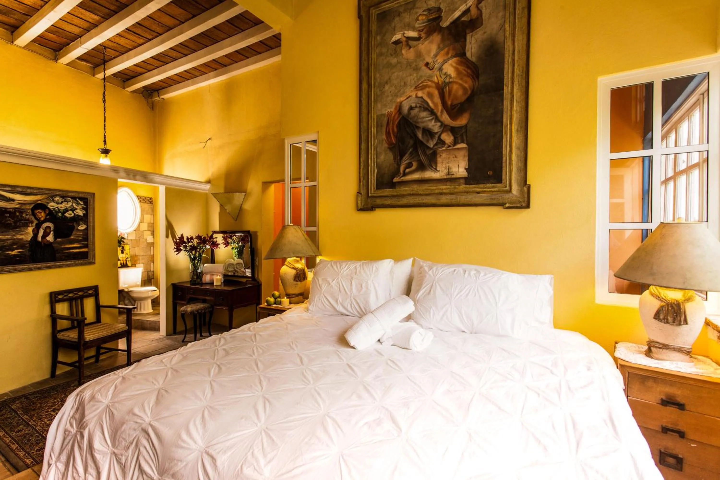 Bed in Garlands Del Rio Riverside Boutique Hotel