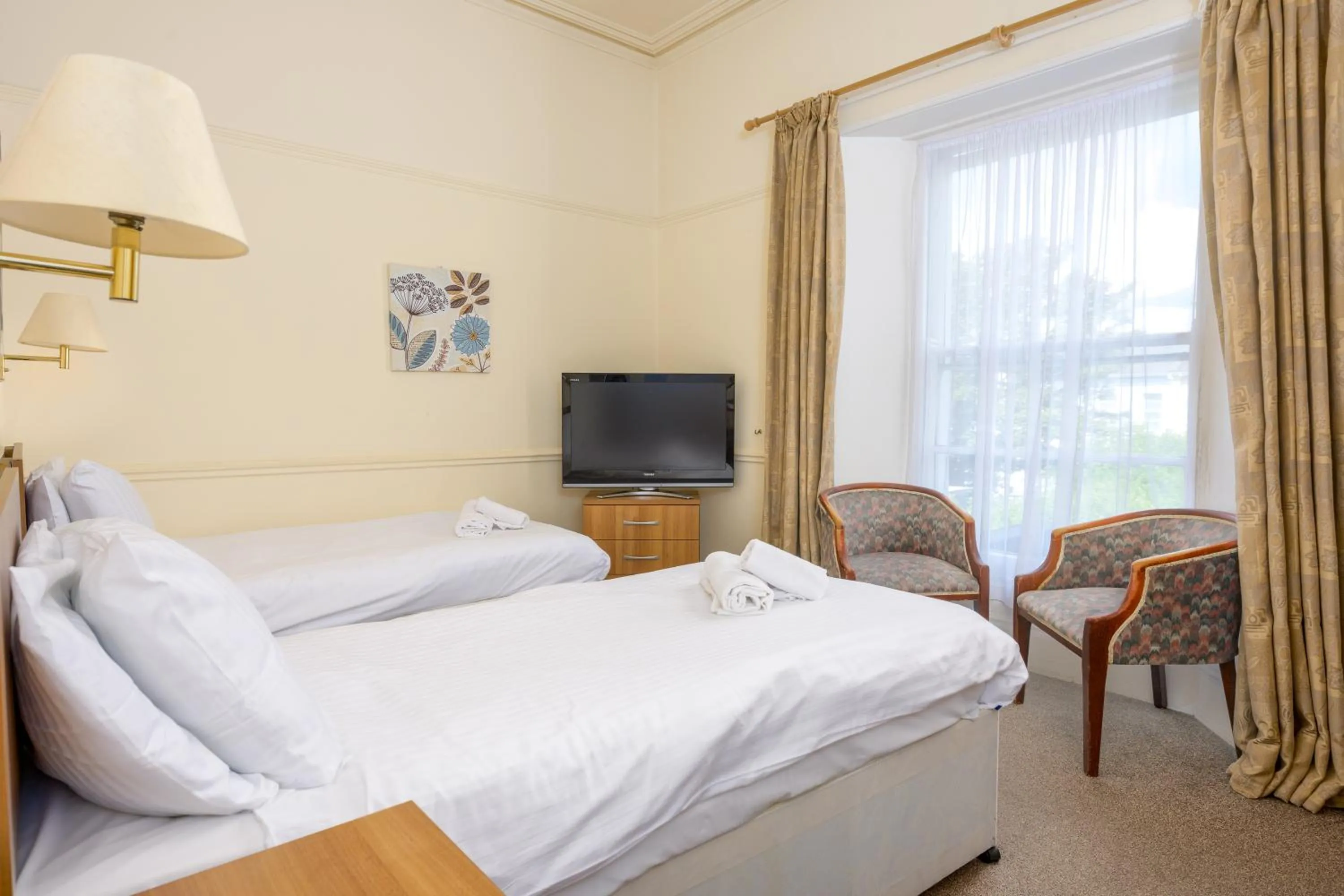 Bed in Abbey Lawn Hotel